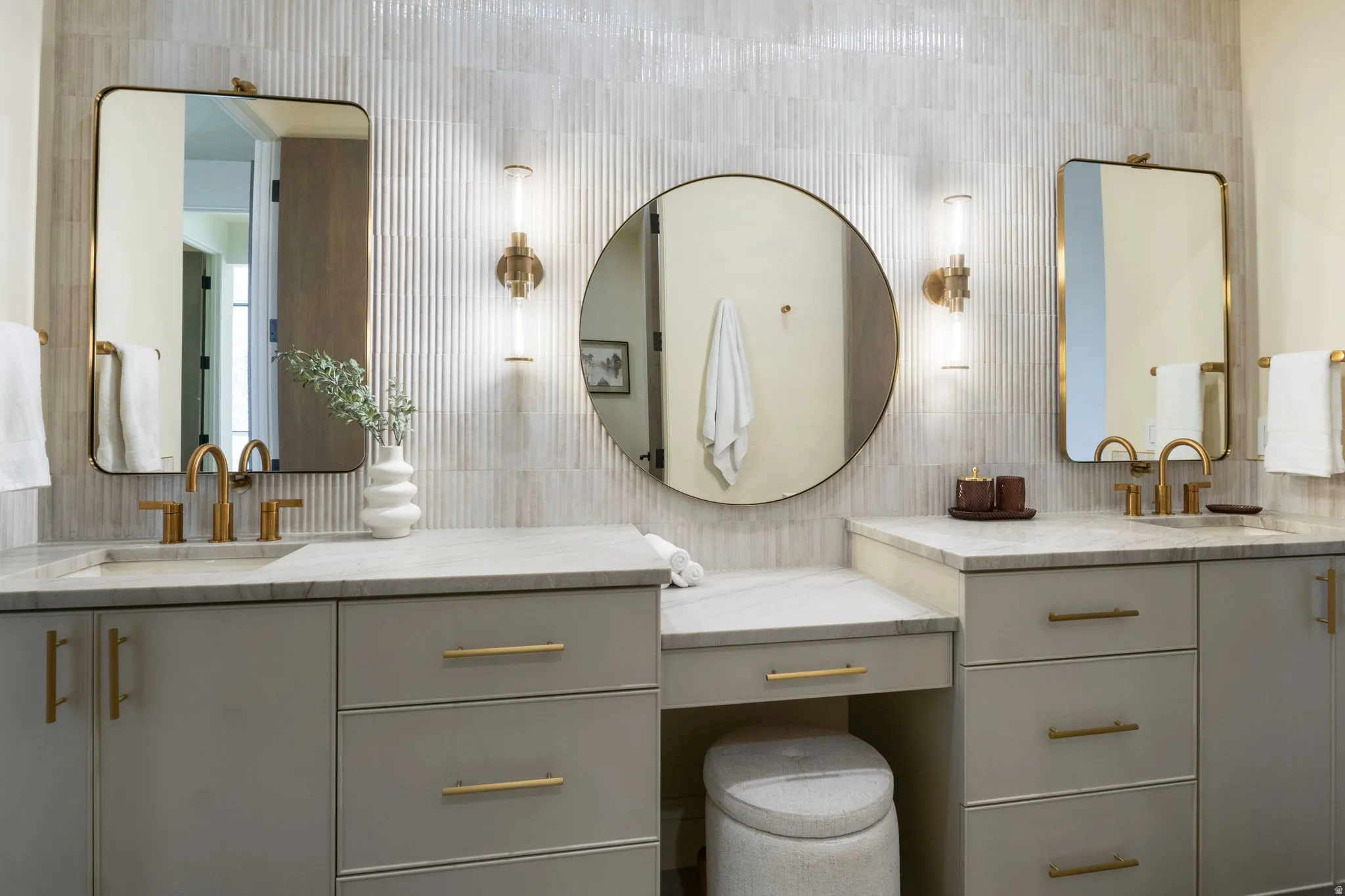 Bathroom with vanity and tasteful backsplash