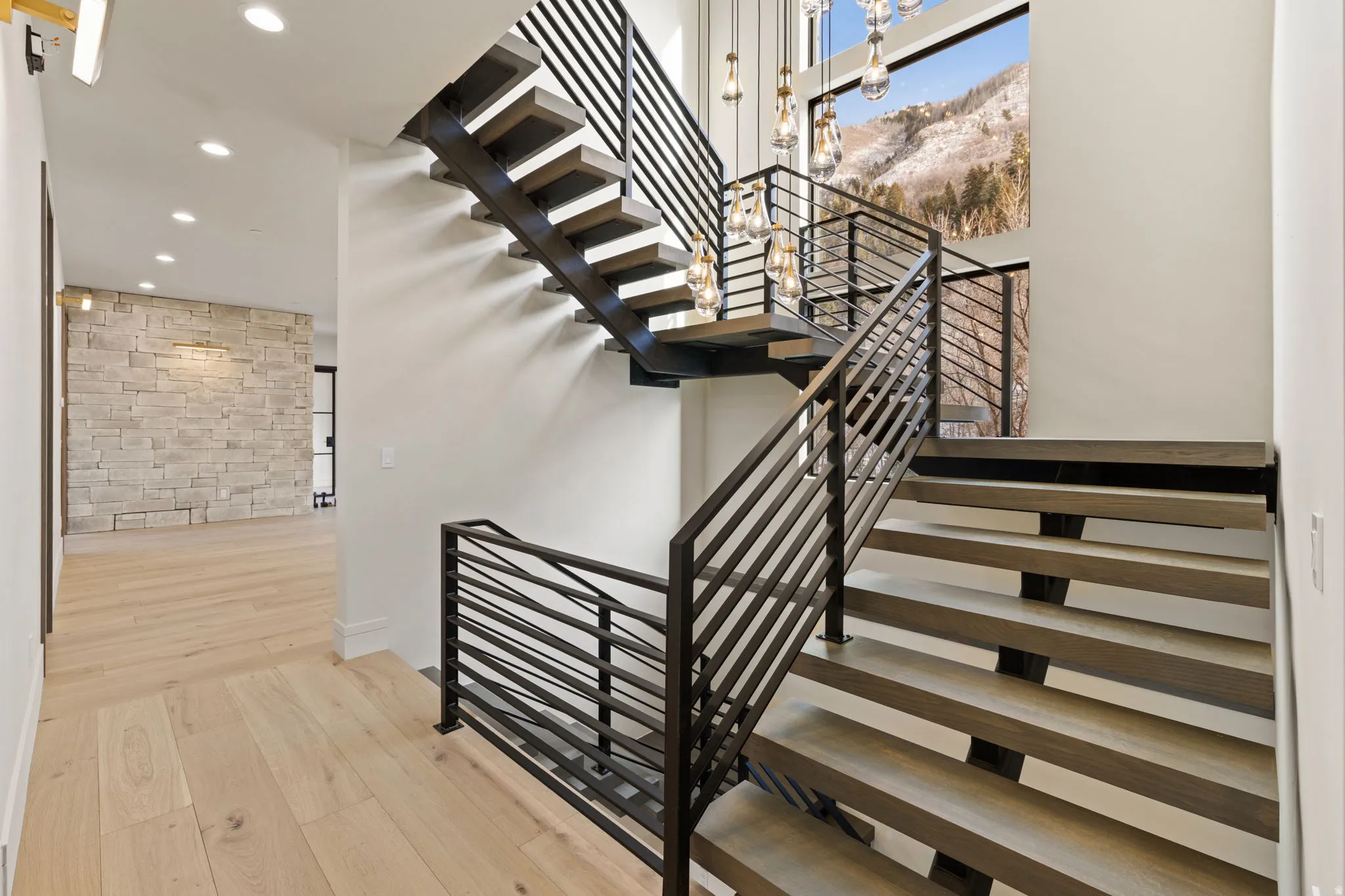 Floating stairs with white oak treads and 2 level stunning chandelier