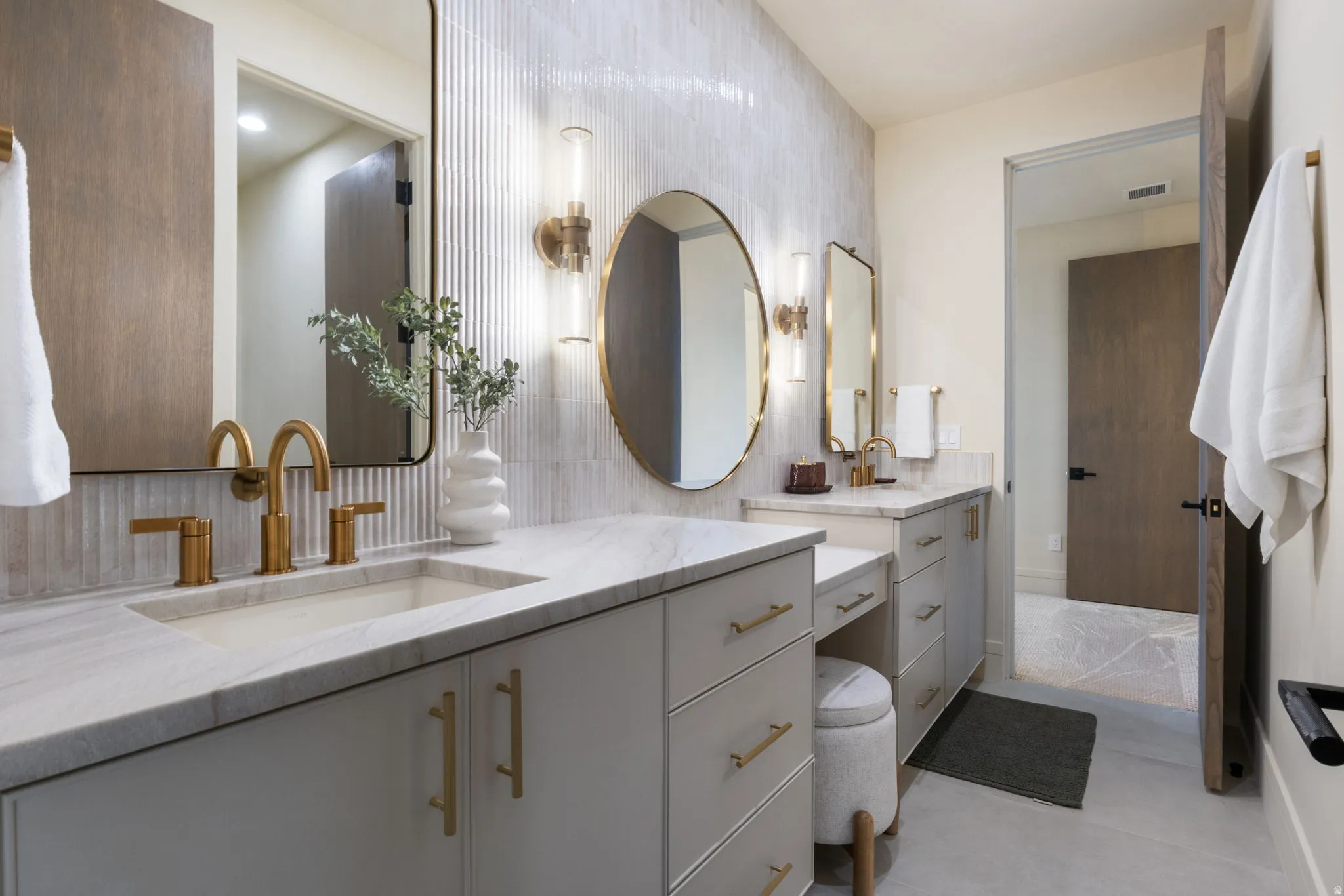 Full bath featuring vanity, tile walls, and backsplash