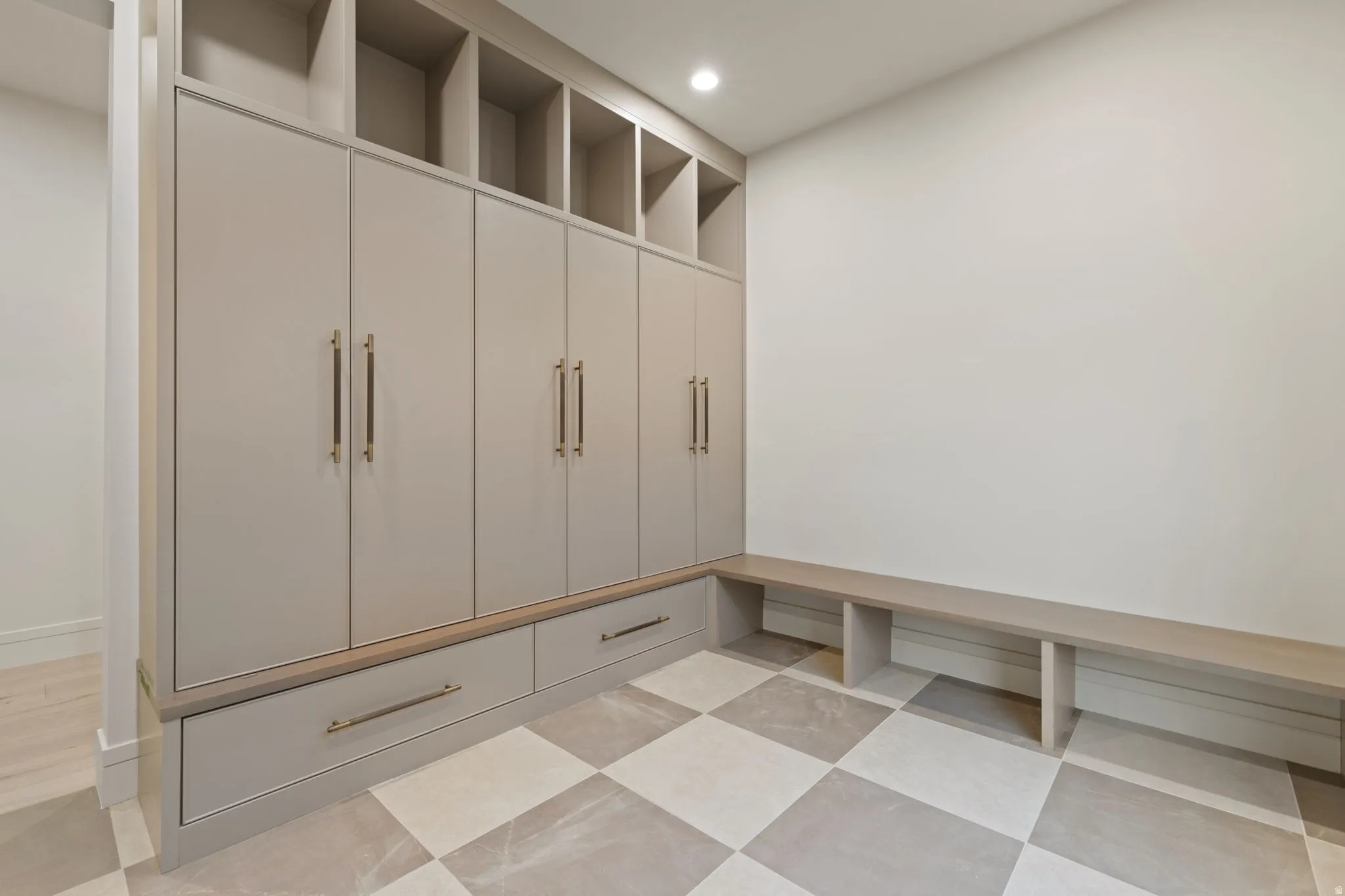 Mudroom with lockers, a bench and tons of shoe  storage