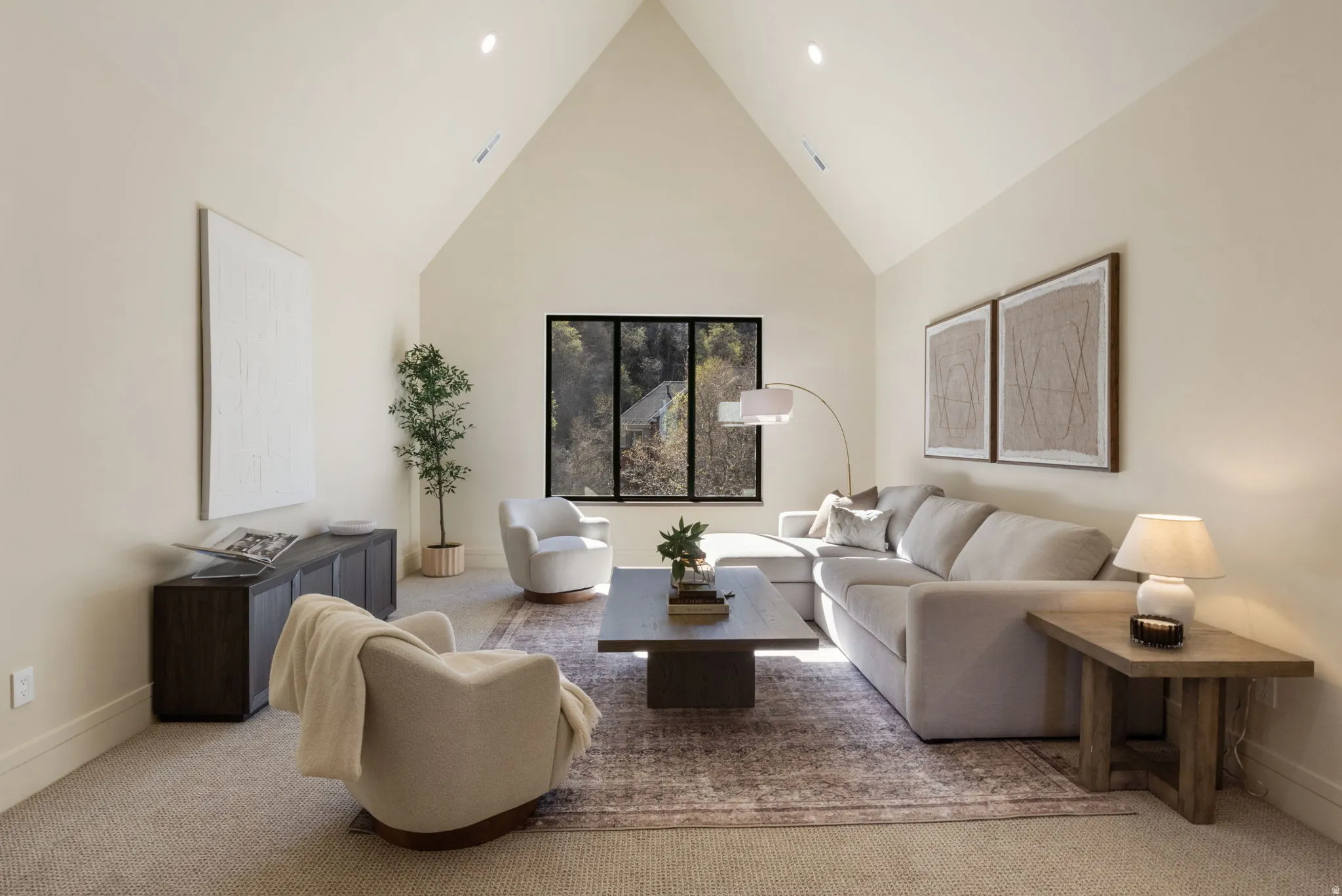 Living room with a high ceiling and carpet flooring