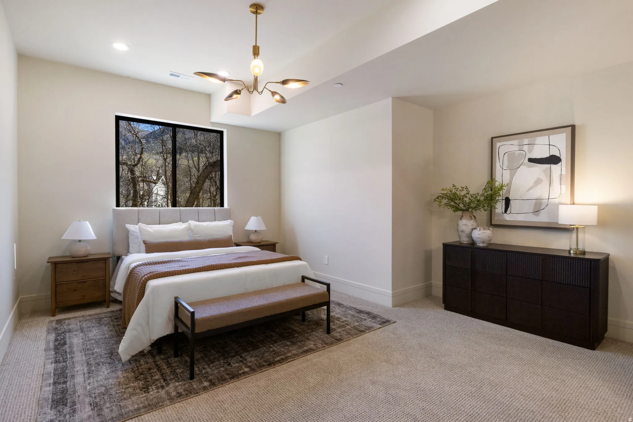 Bedroom featuring carpet and hanging lights