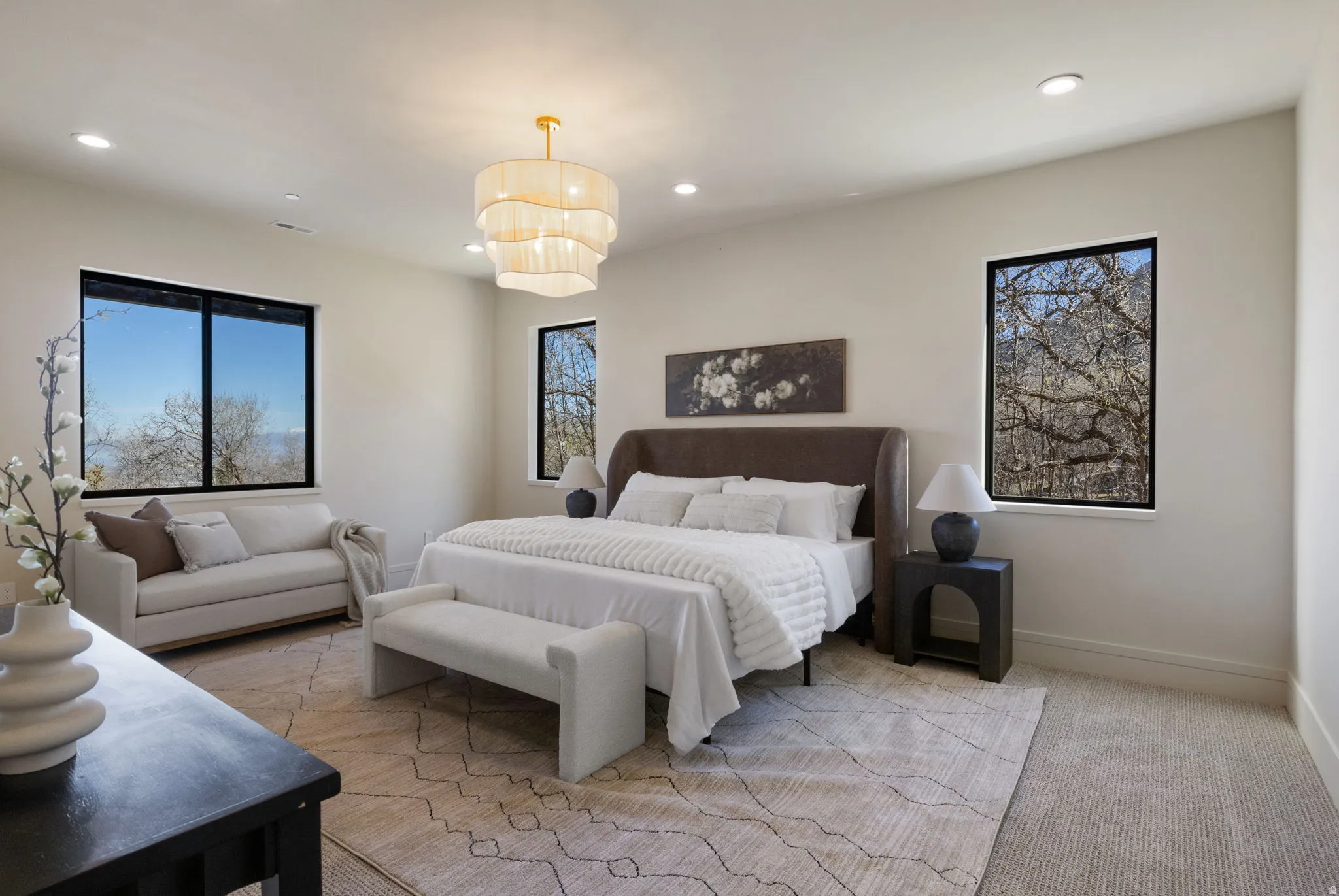 Bedroom with light carpet, recessed lighting, and multiple windows