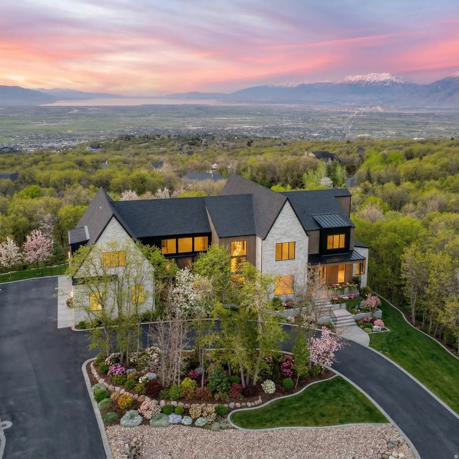 View of front of home with stone siding, a standing seam roof, a mountain view, and a balcony