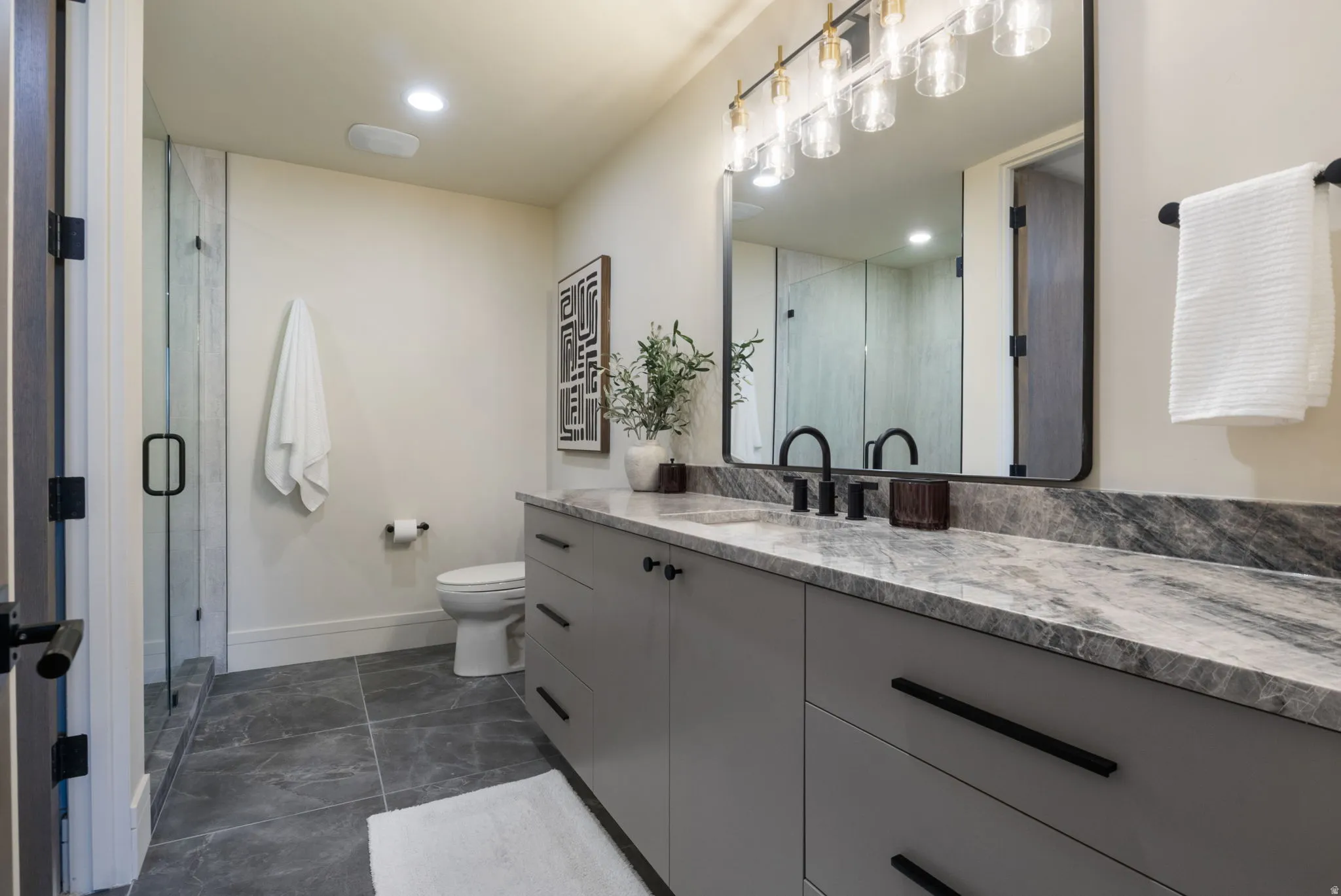 Bathroom with vanity, a shower stall, and recessed lighting