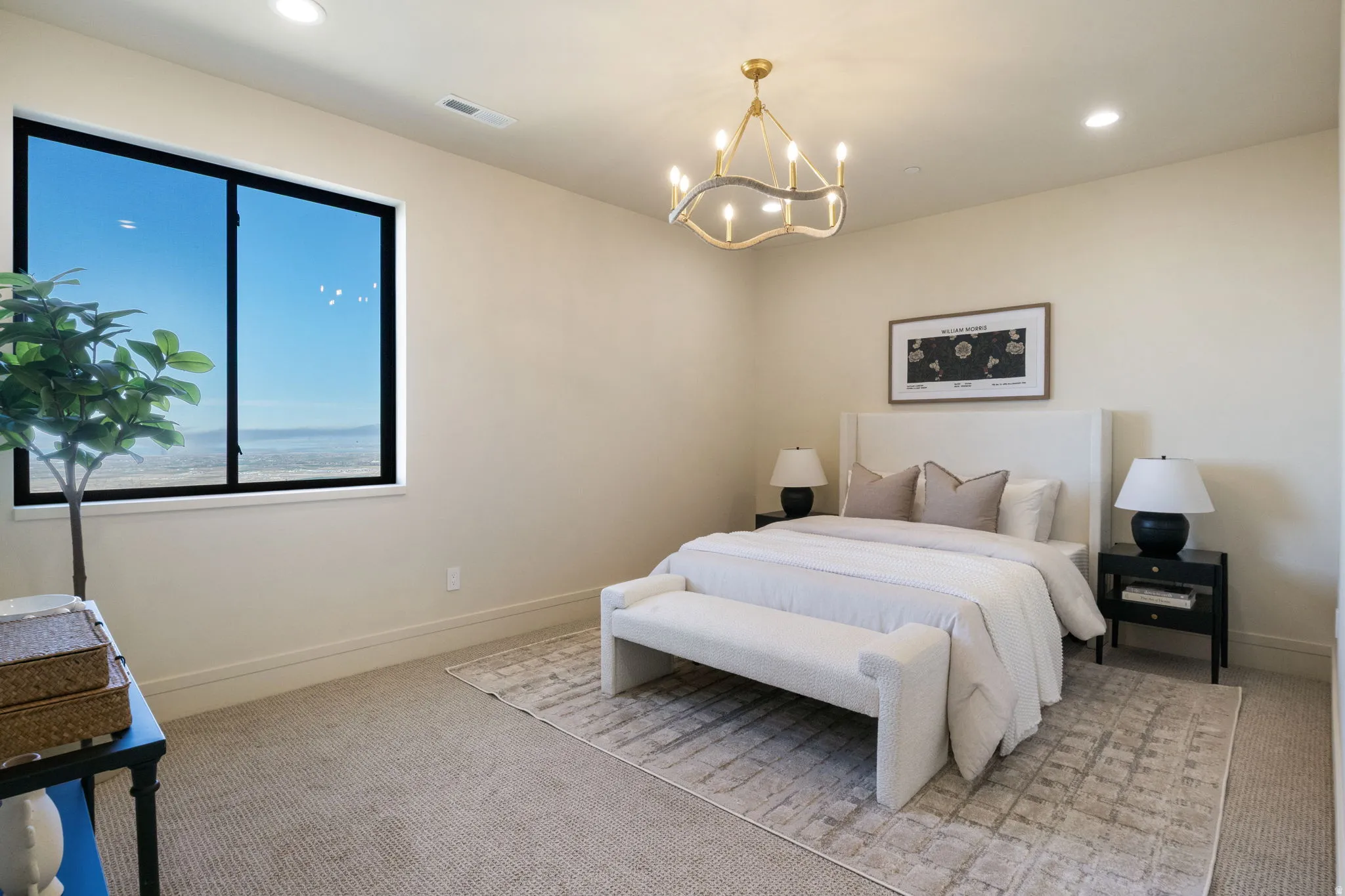 Bedroom with light carpet and a chandelier