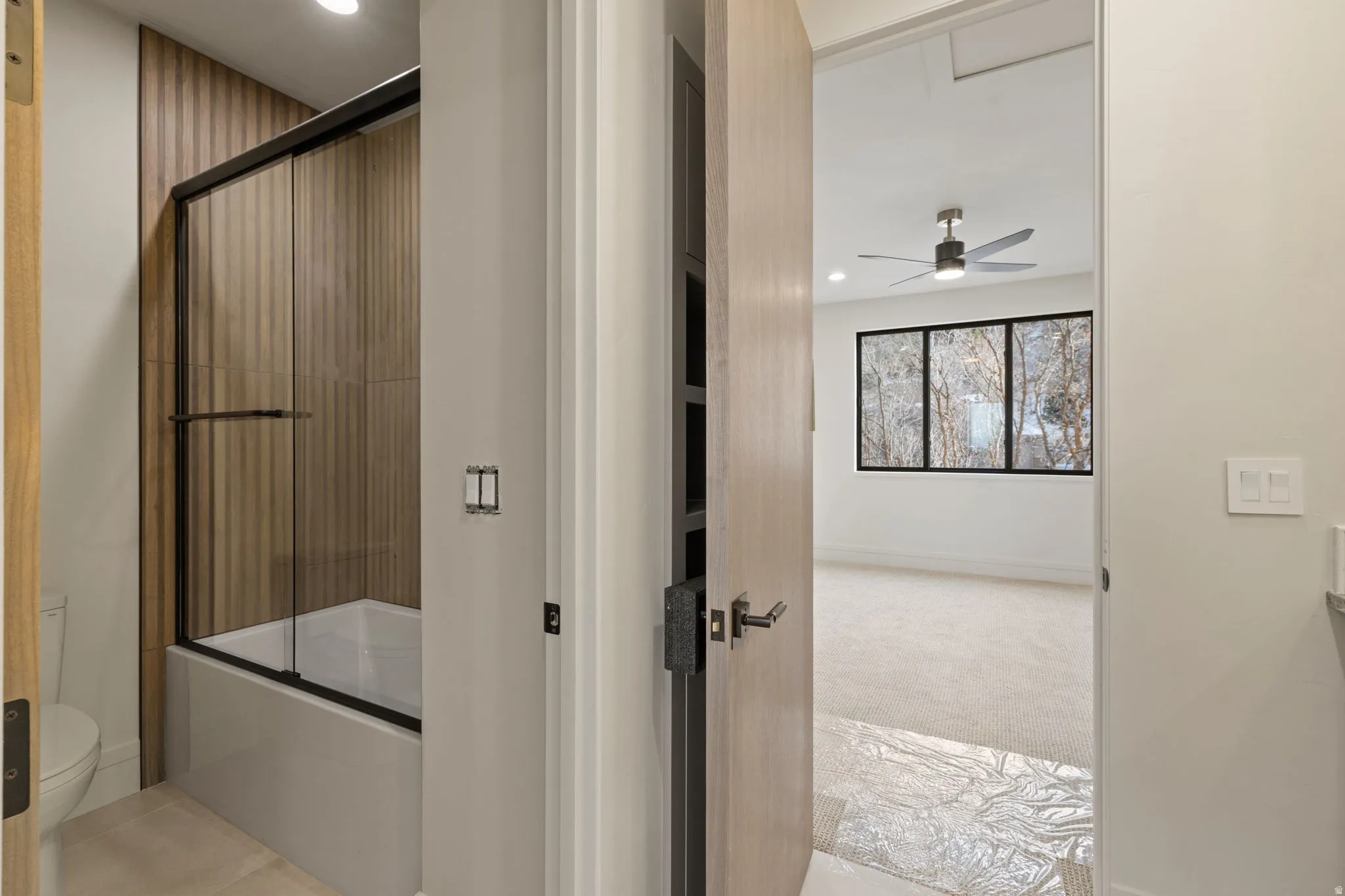 Bathroom with shower / bath combination with glass door, light carpet, recessed lighting, vanity, and ceiling fan