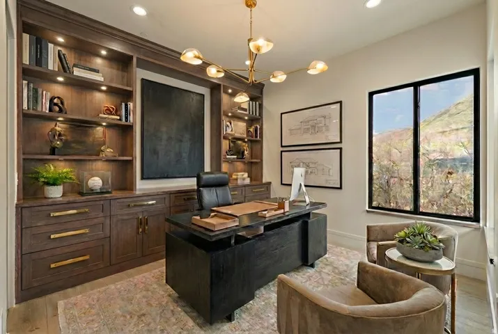 Office area featuring light wood-style floors, suspended lighting, and built in shelves