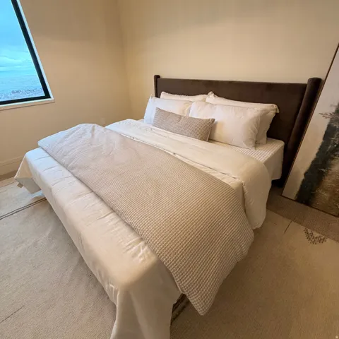 Bedroom featuring carpet and baseboards