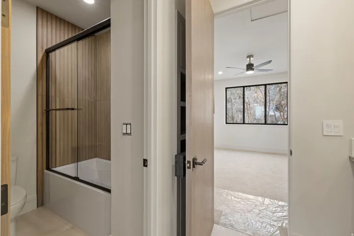 Bathroom with shower / bath combination with glass door, light carpet, recessed lighting, vanity, and ceiling fan