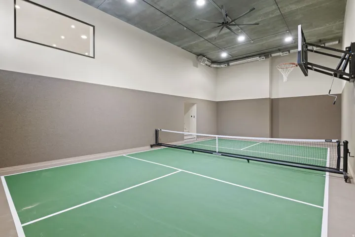 View of pickleball court featuring a ceiling fan