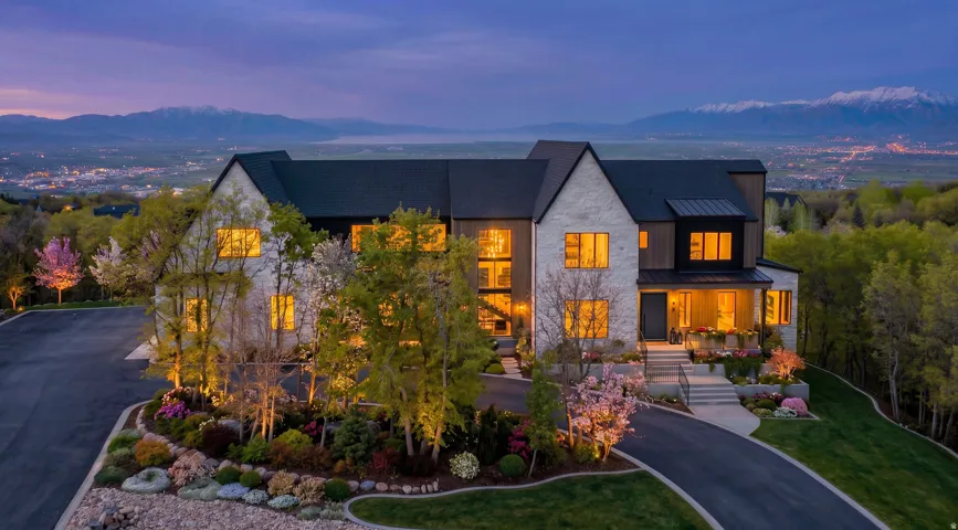 Contemporary stone and dark siding exterior with multiple gables