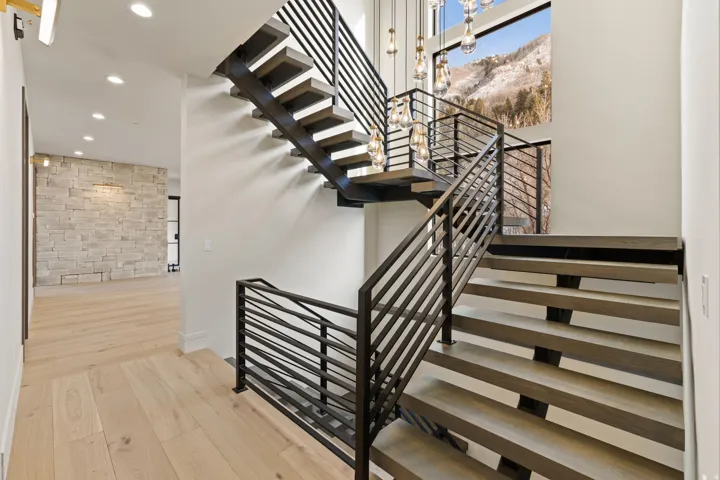 Floating stairs with white oak treads and 2 level stunning chandelier