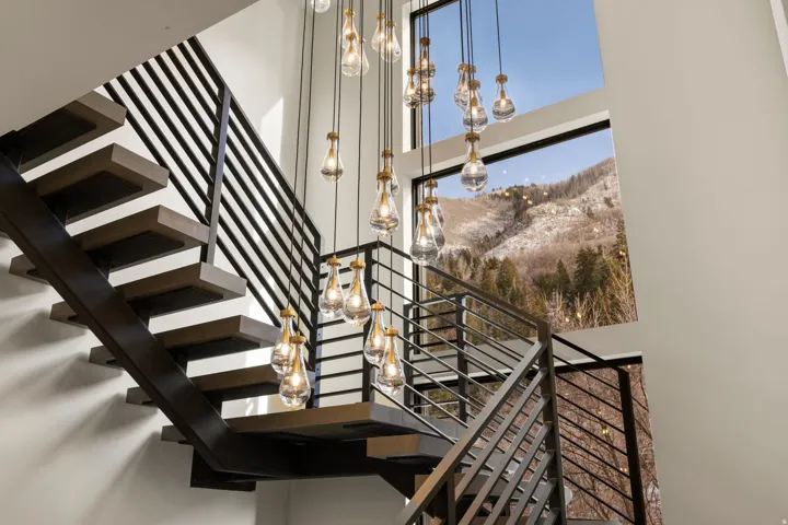 Floating stairs with white oak treads and 2 level stunning chandelier