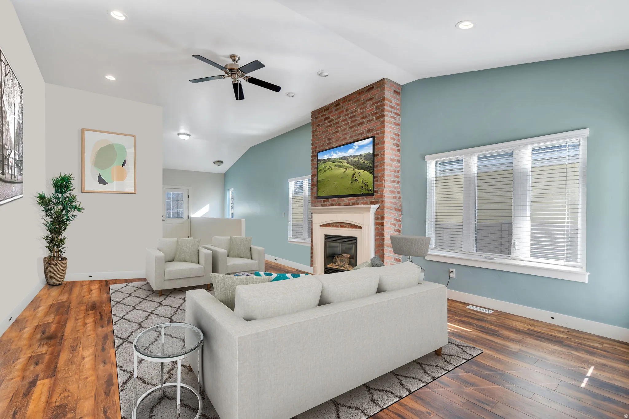 Warm and inviting great room featuring a stunning floor-to-ceiling brick fireplace—the perfect gathering space for relaxing evenings, entertaining guests, or spending time with family.