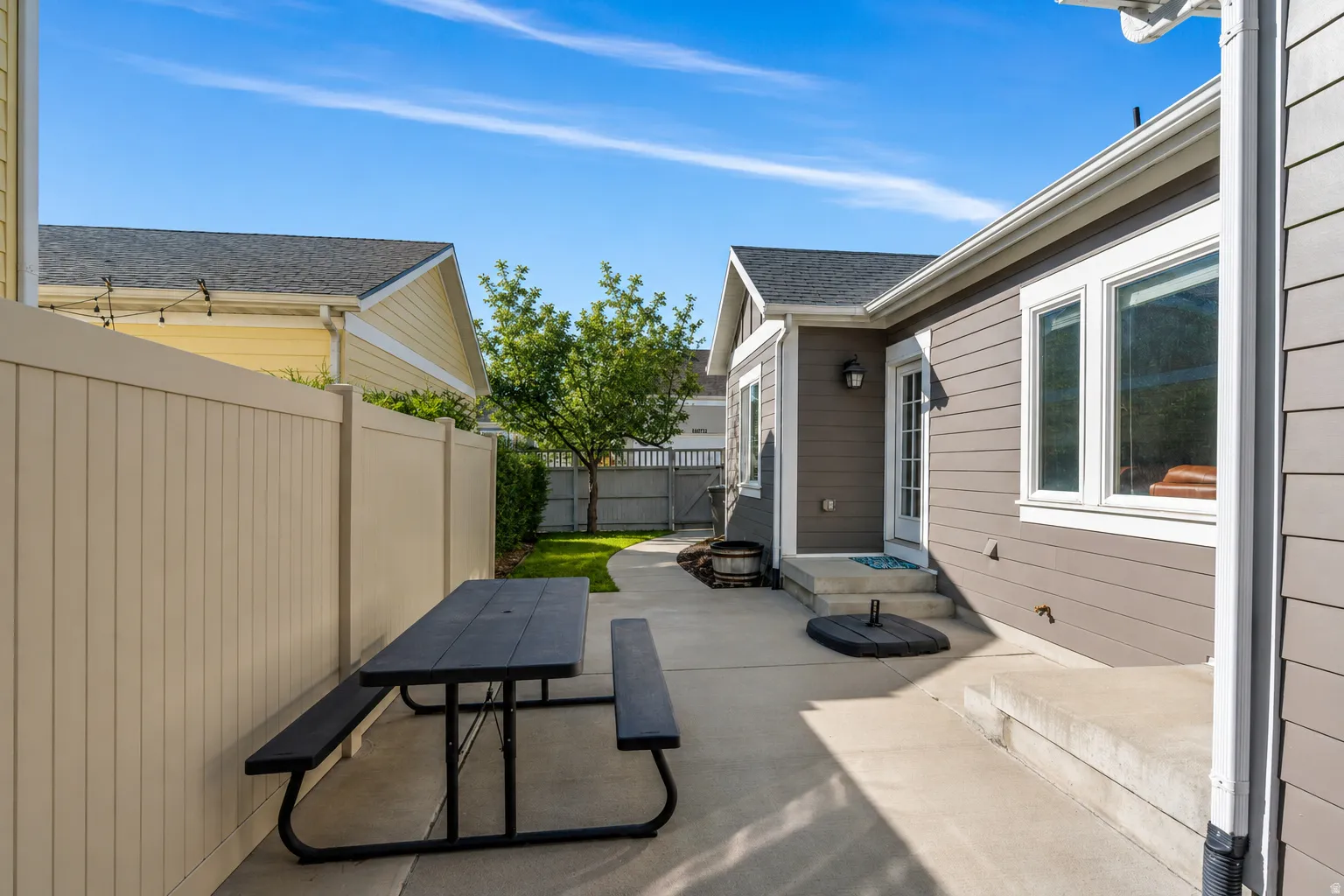 Fenced backyard featuring outdoor dining area and a patio