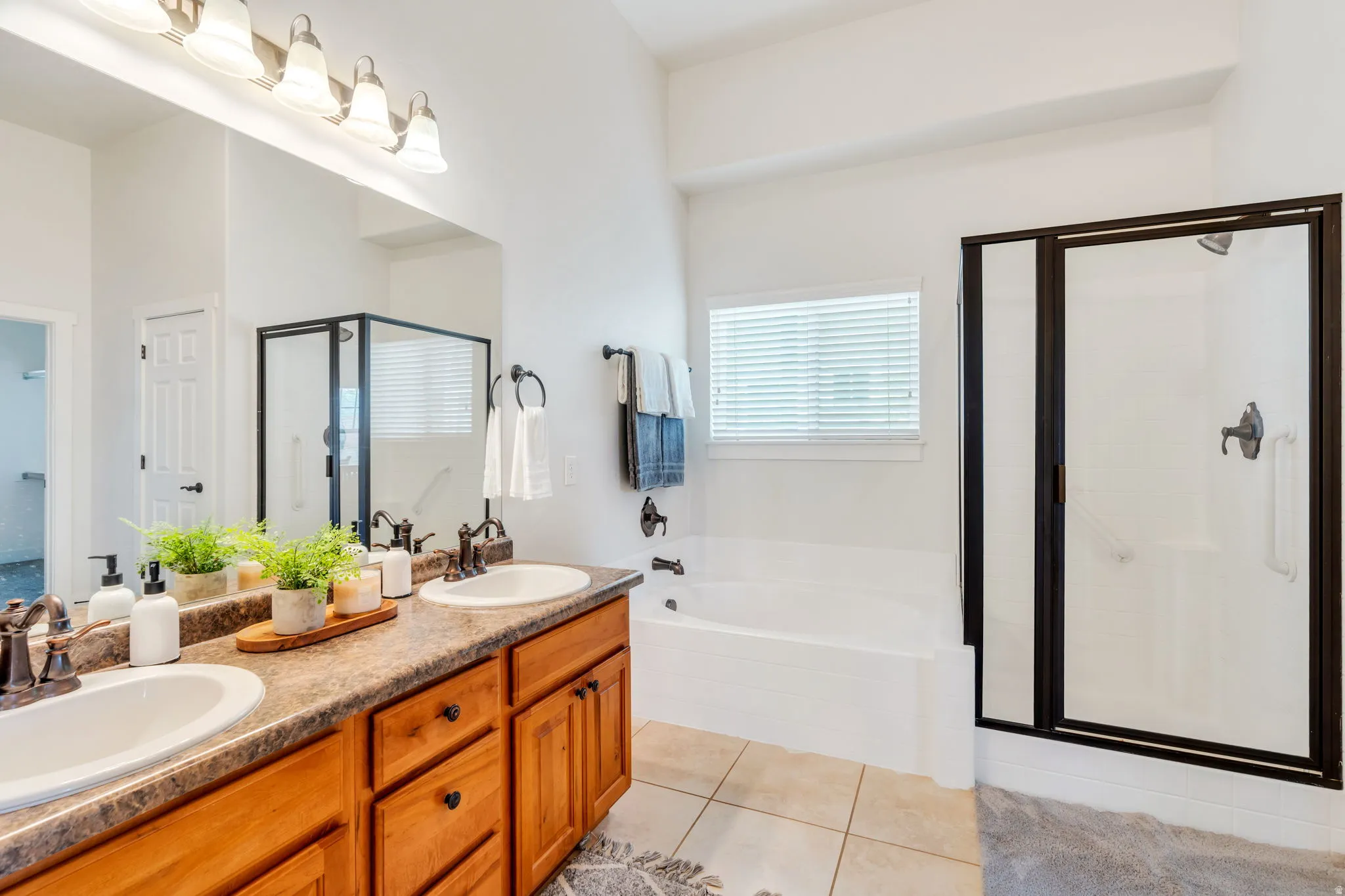 Updated primary bathroom featuring a beautiful Euro-style shower and a fresh, modern feel.