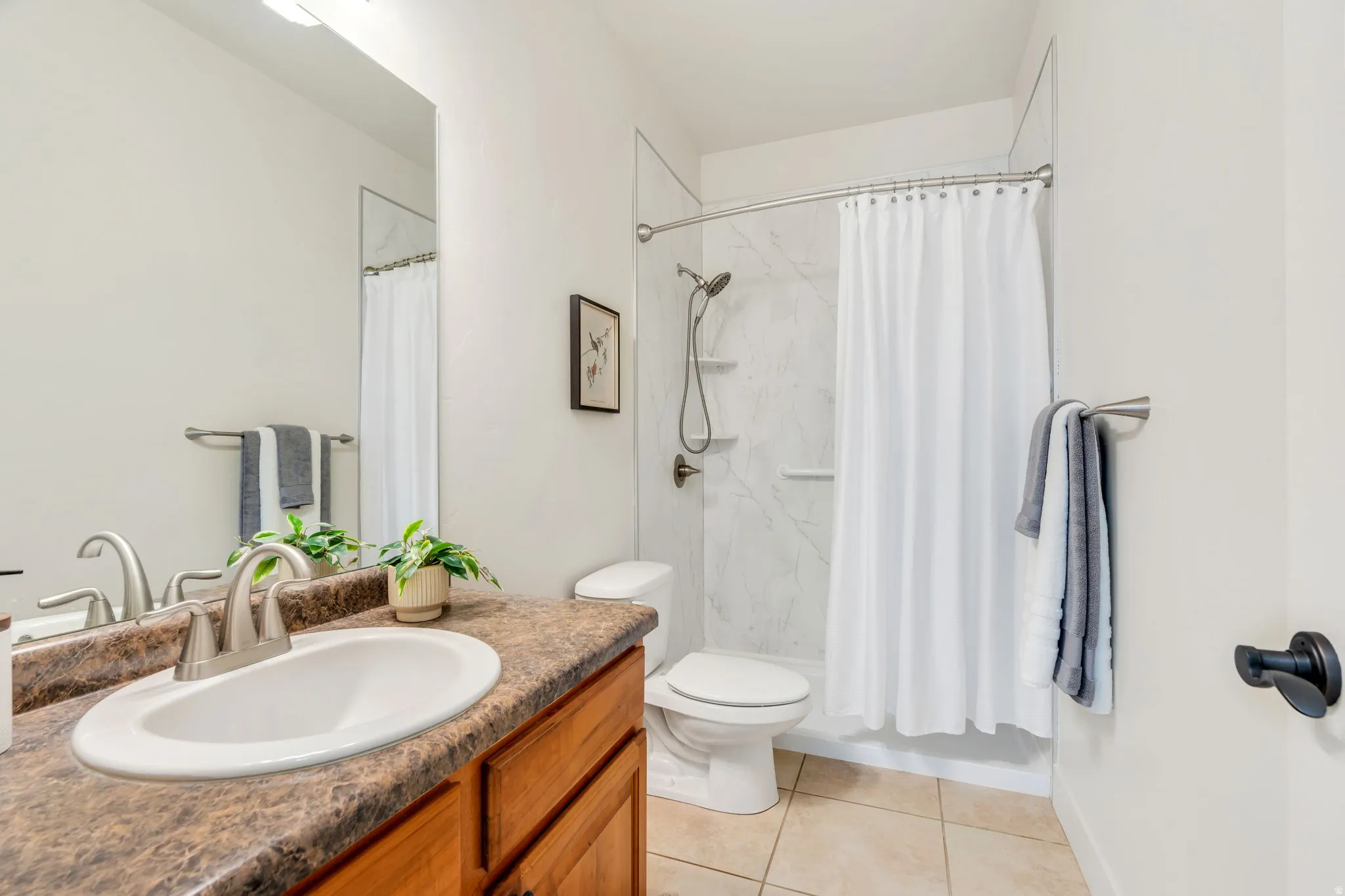 Full bathroom #2 upstairs has bath and shower combination near the additional bedrooms, providing the potential for guest suites.