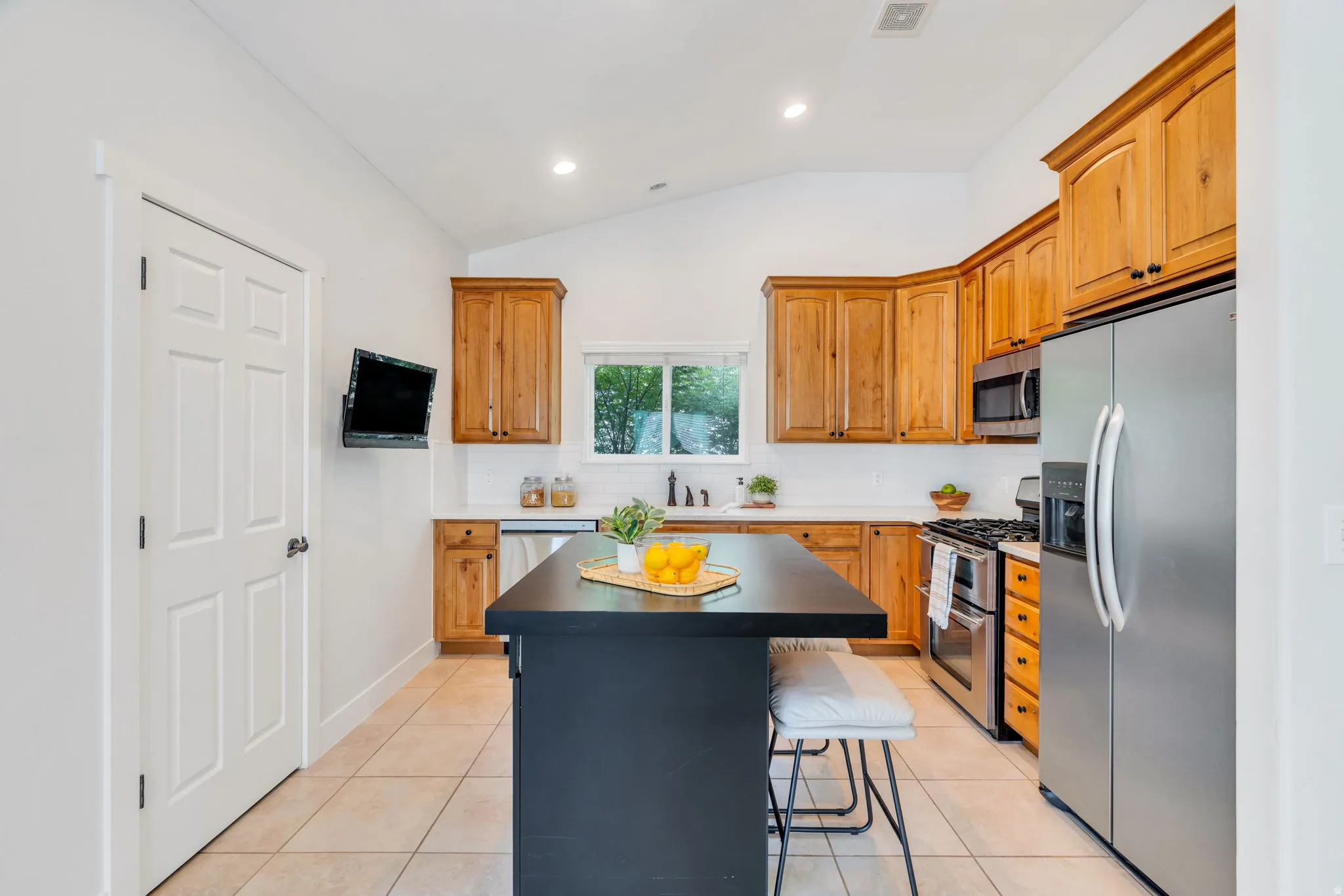 A portable island is included with the kitchen, adding to workspace and bar dining.