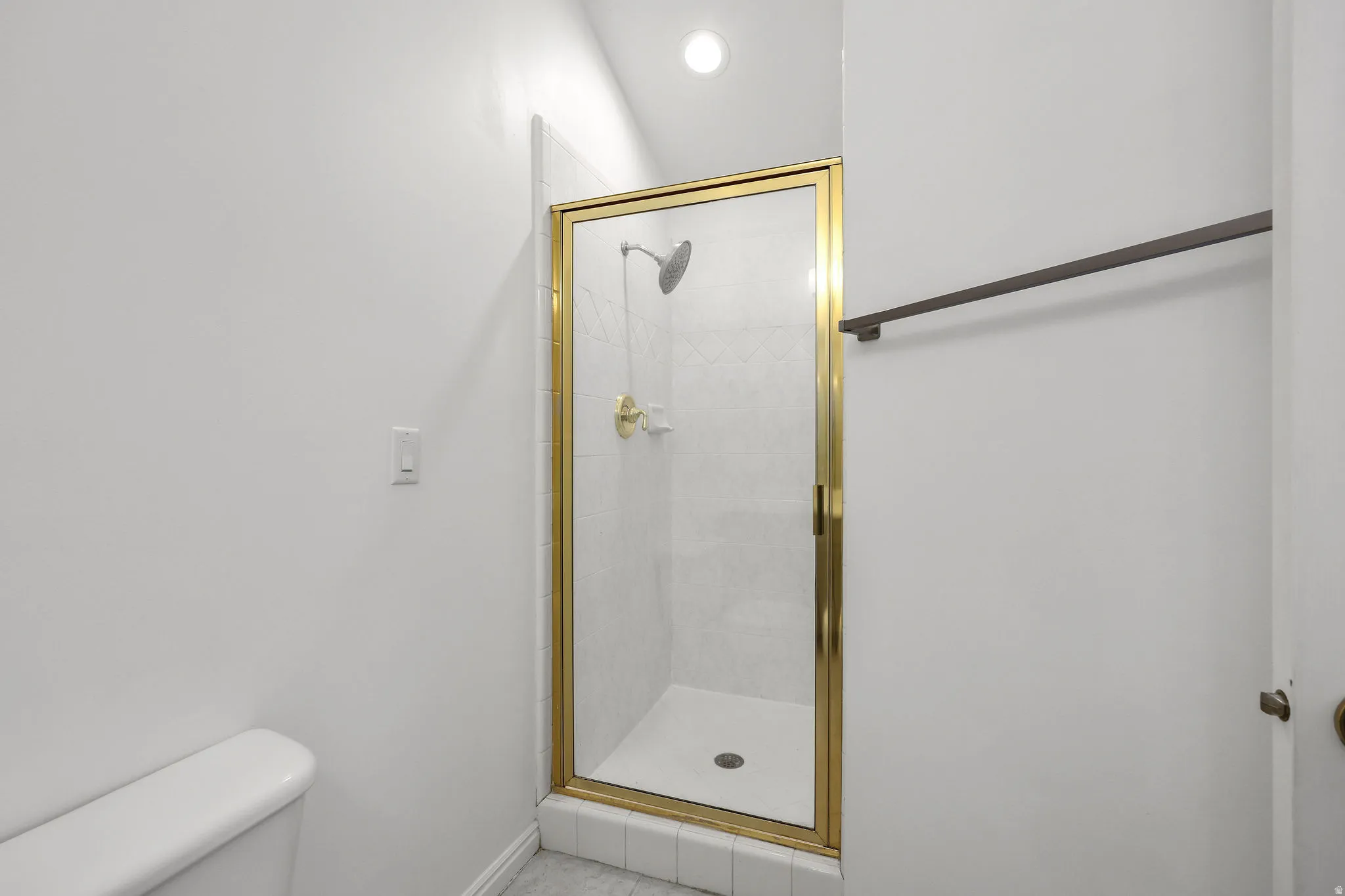 Bathroom featuring a stall shower and recessed lighting