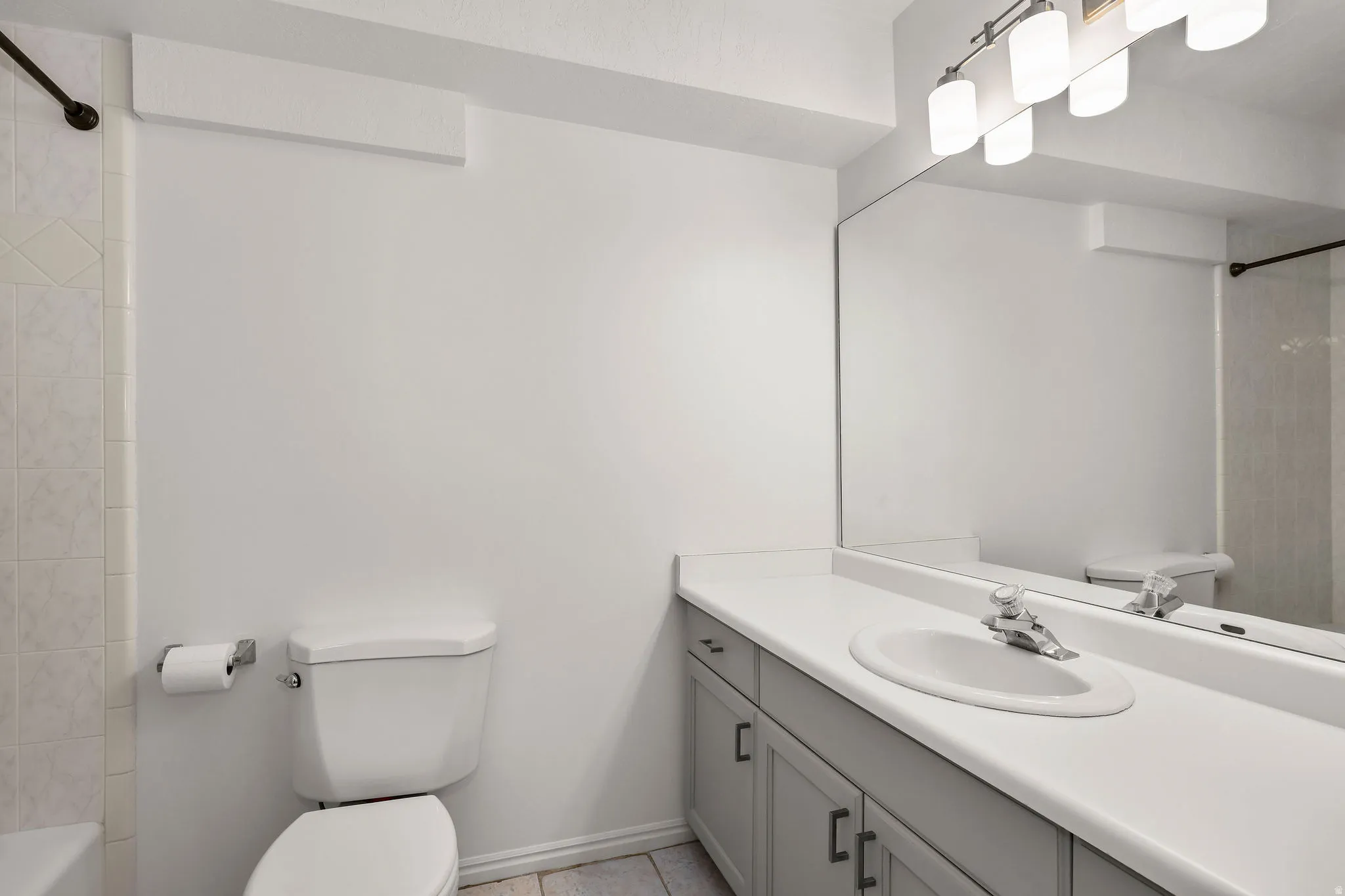 Full bath featuring  shower combination and vanity