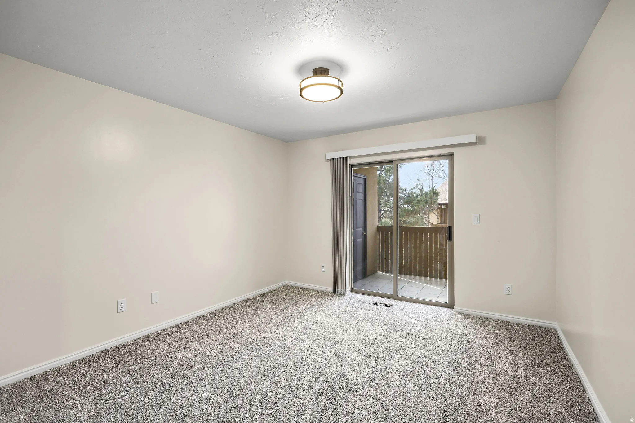 Large bedroom with a walkout balcony