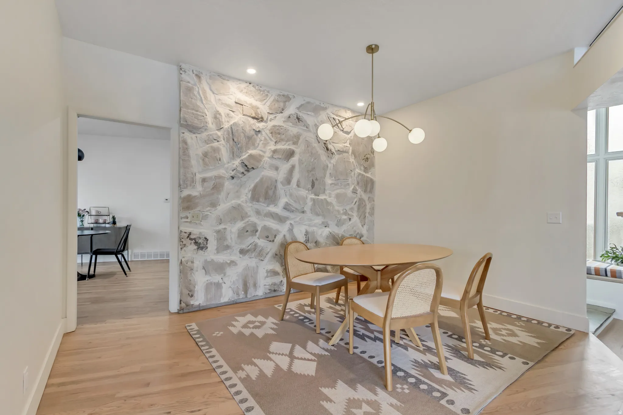 Dining room featuring light wood finished floors, a chandelier, and recessed lighting