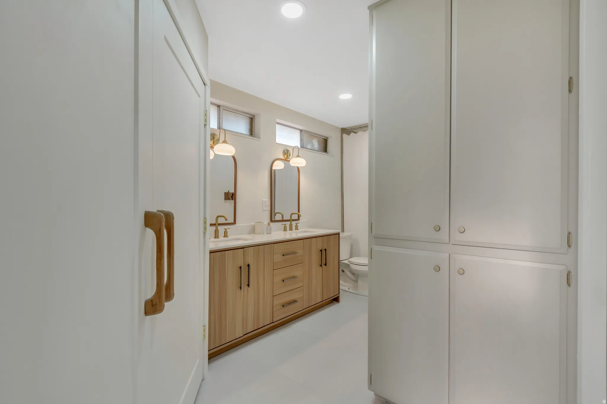 Full bathroom featuring double vanity and recessed lighting