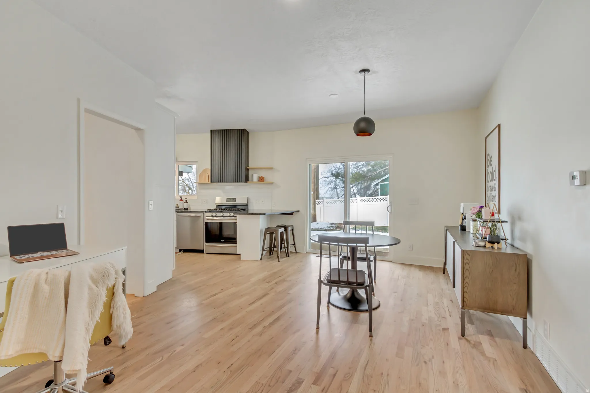 Dining space with light wood-style floors and baseboards