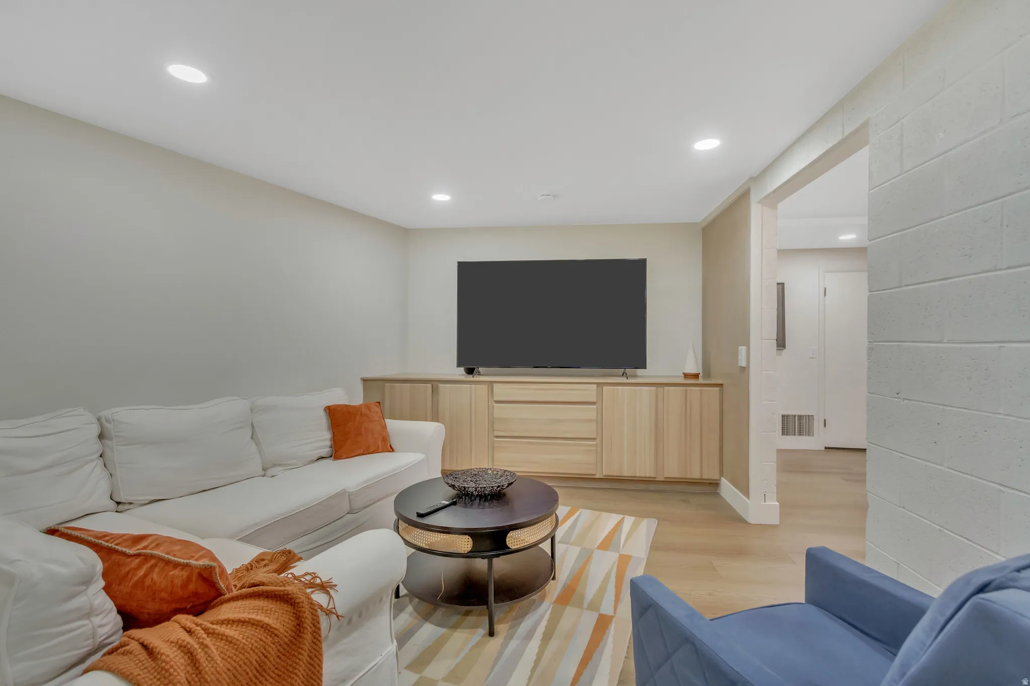 Living room with recessed lighting and light wood-style floors