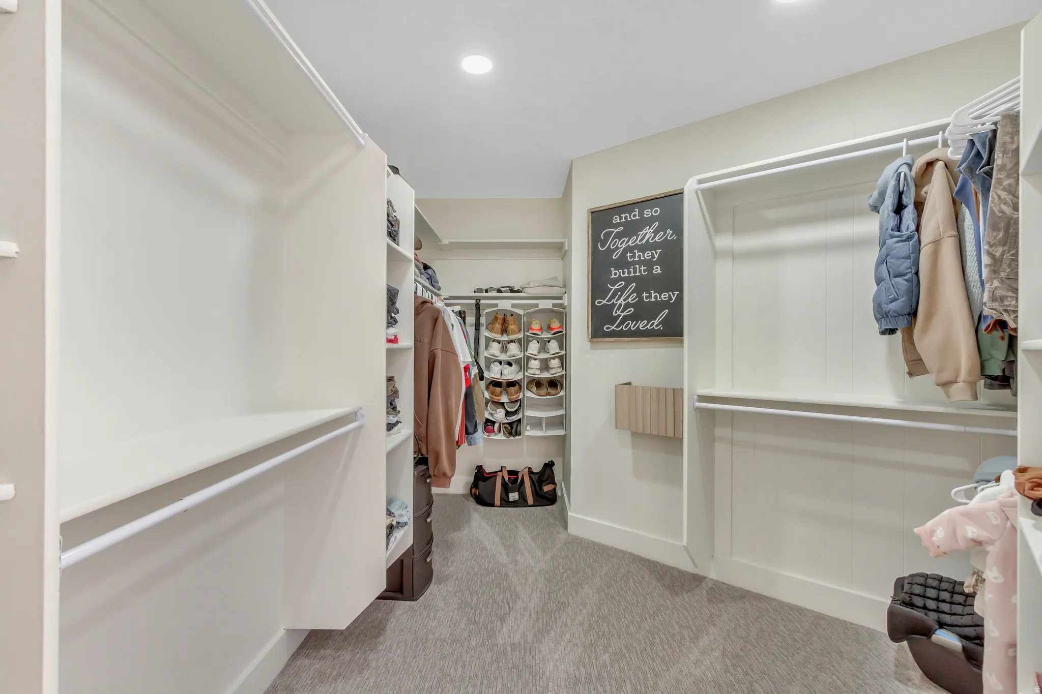Spacious closet featuring light colored carpet
