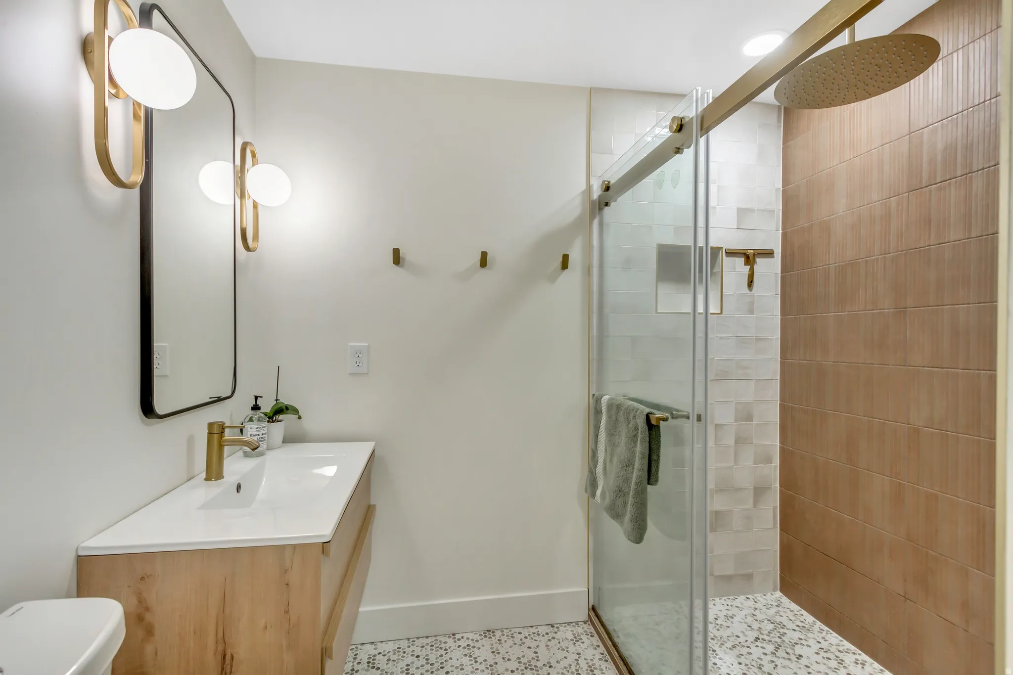 Bathroom with a stall shower and vanity