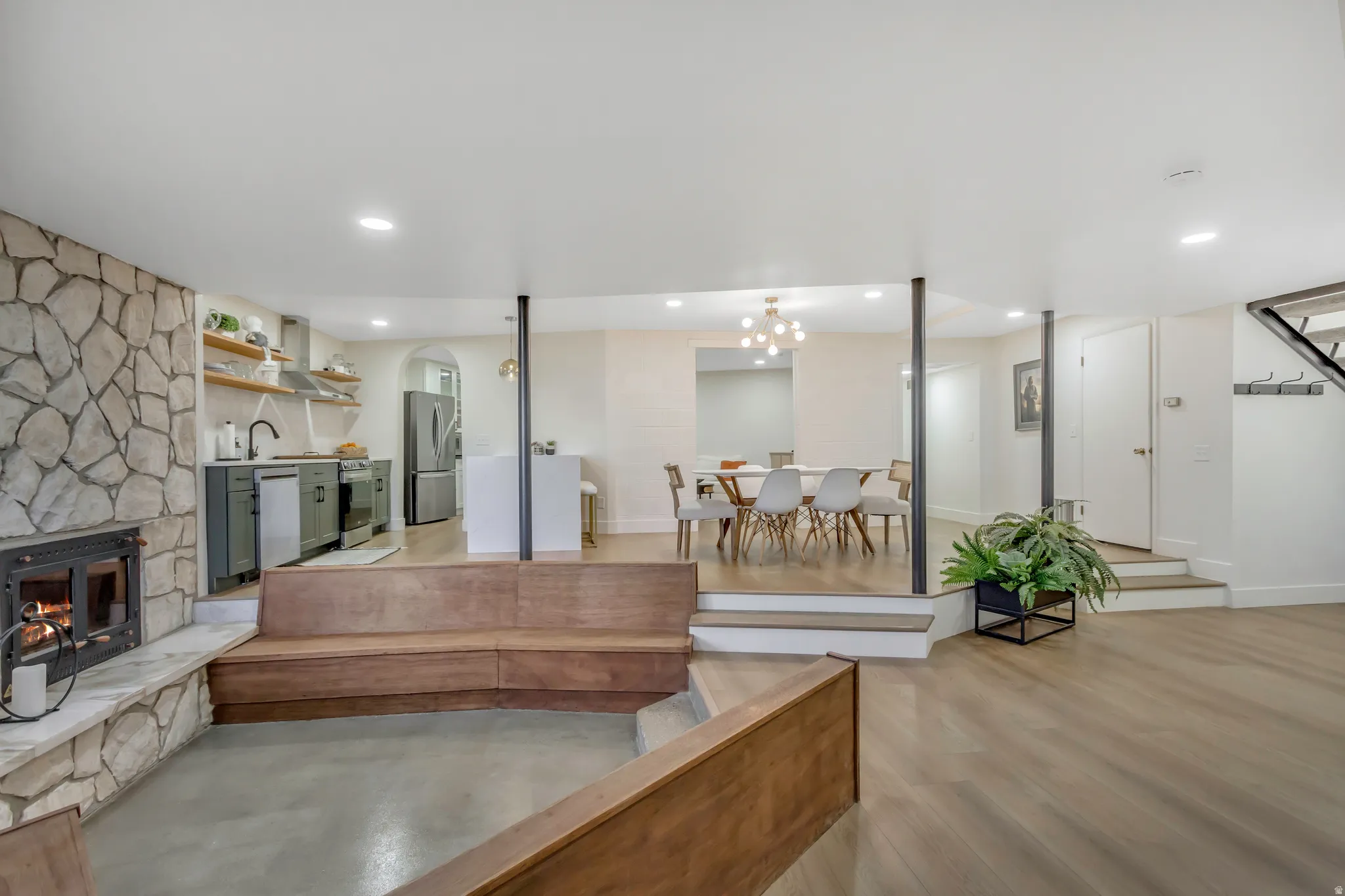 Living room featuring a stone fireplace and recessed lighting