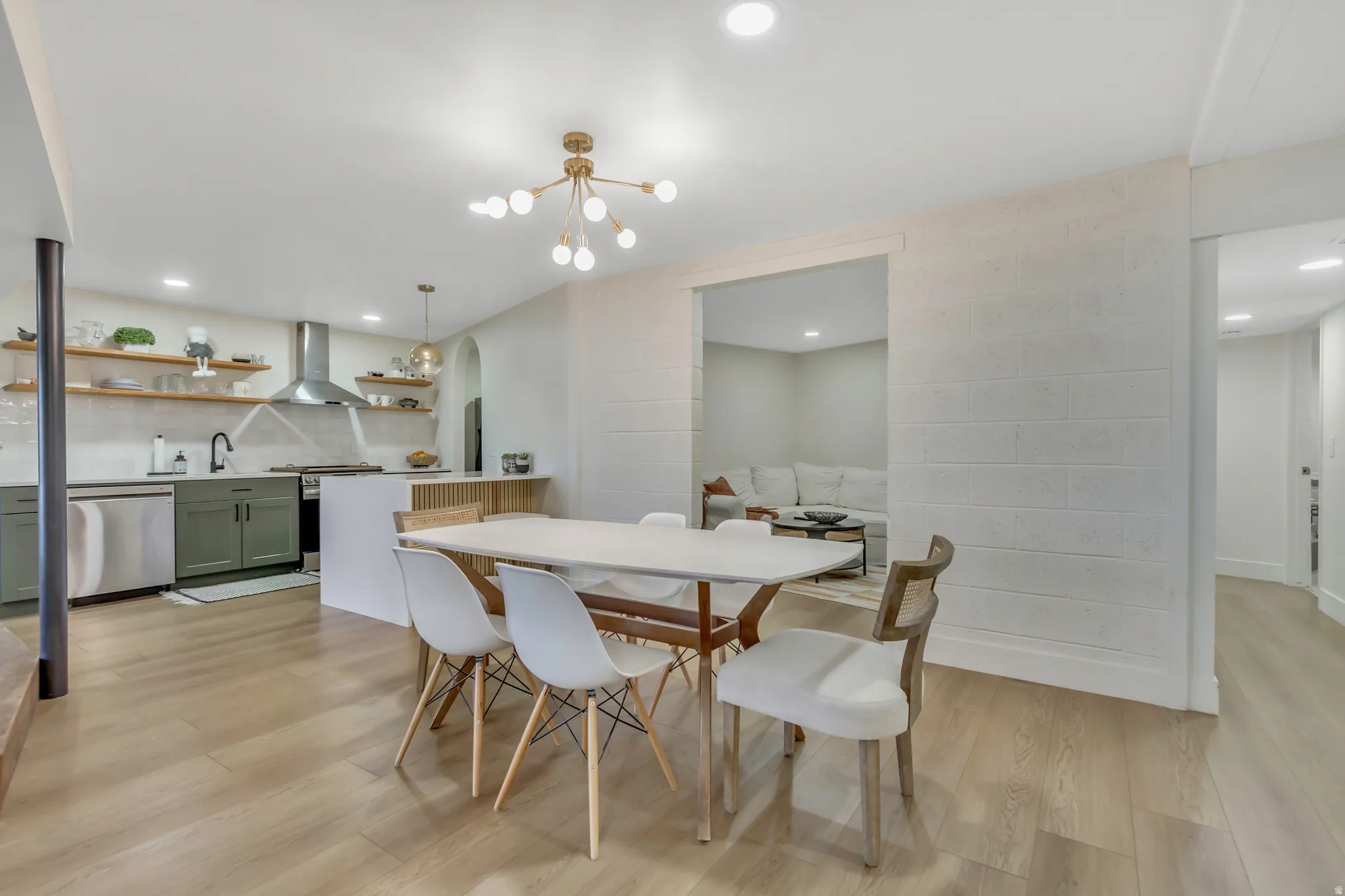 Dining room featuring light wood-type flooring, a chandelier, and recessed lighting