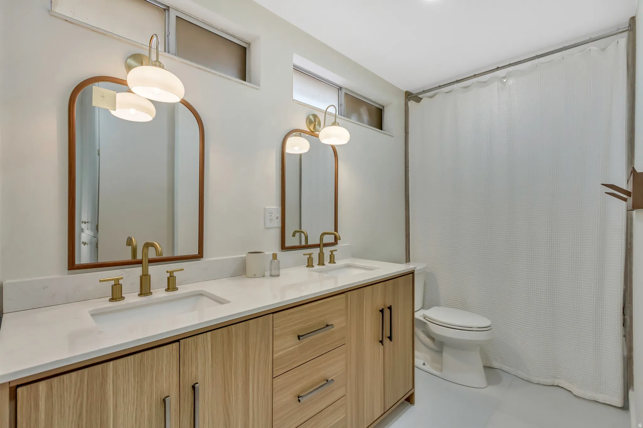 Bathroom with double vanity and toilet