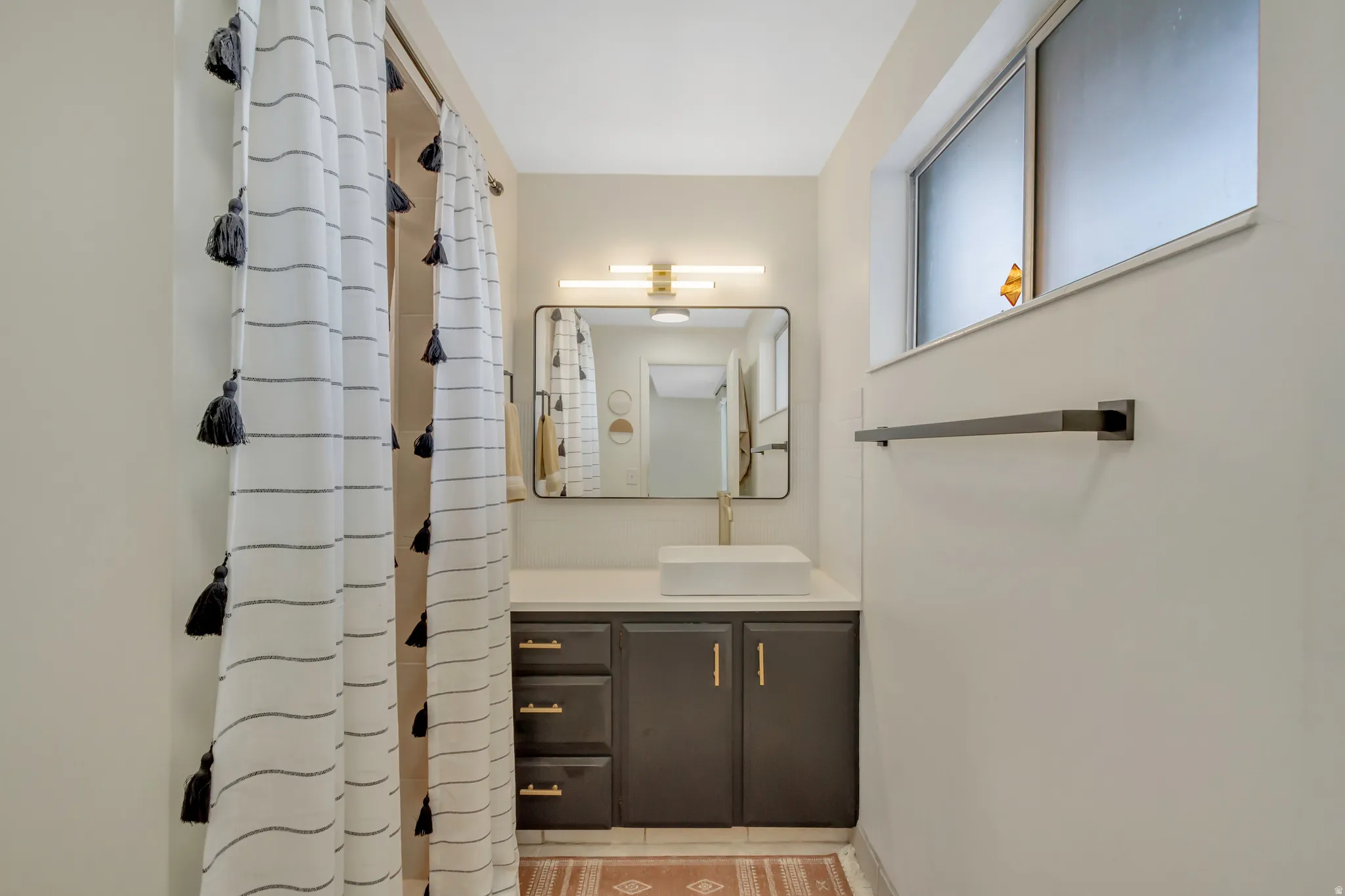 Bathroom with vanity and curtained shower