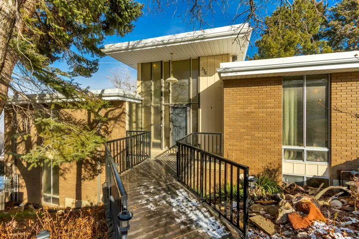 View of exterior entry featuring brick siding