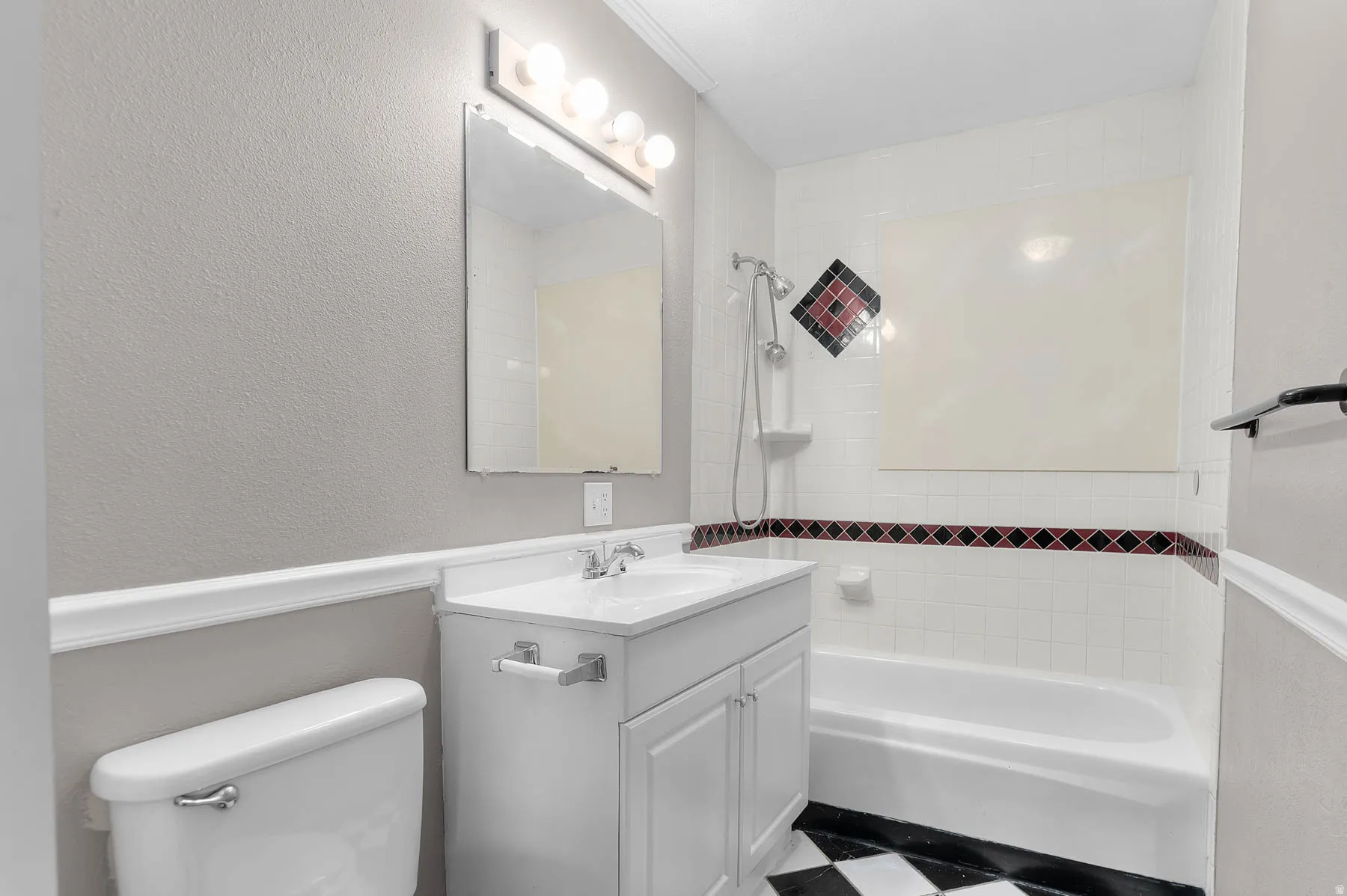 Full bath with shower / bath combination, vanity, a textured wall, and tile patterned floors