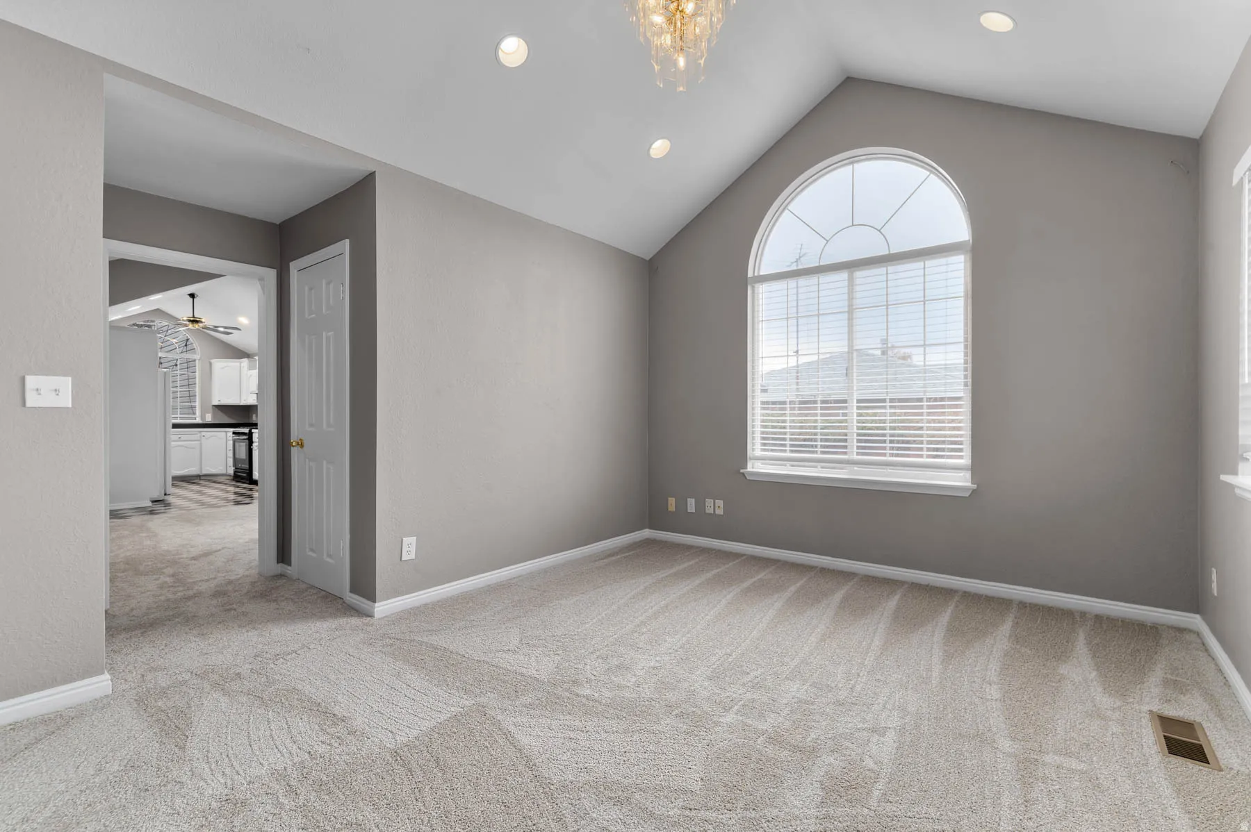 Spare room featuring light colored carpet, recessed lighting, and ceiling fan