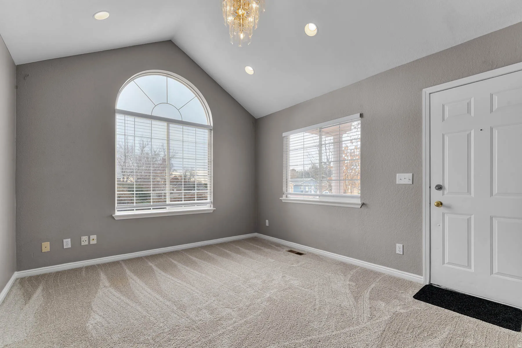 Foyer featuring light carpet and suspended lighting
