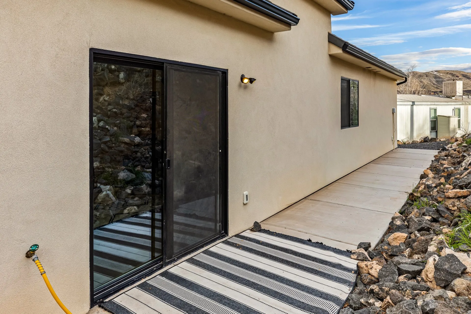 Property entrance with stucco siding and a mountain view