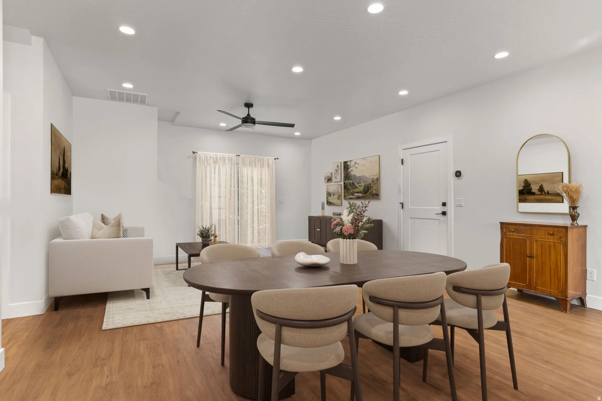 Dining area featuring light wood-style flooring, a ceiling fan, and recessed lighting