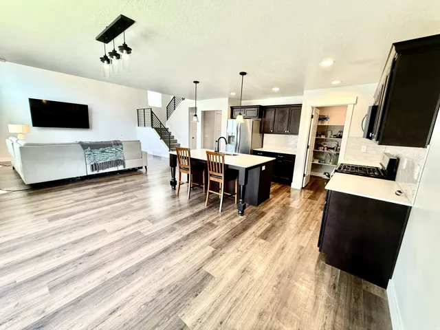 Open-concept living space with wood-finish flooring throughout