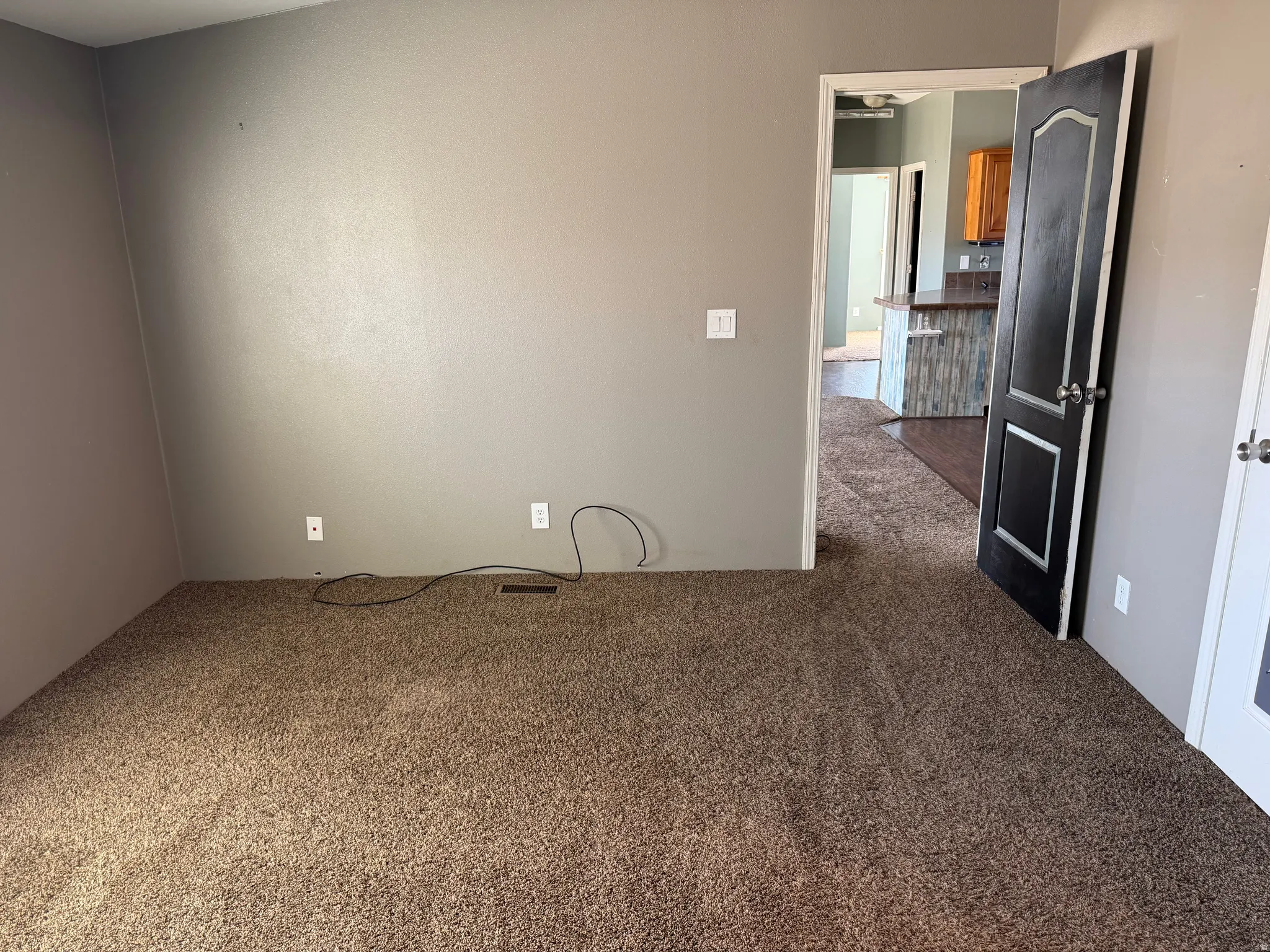Empty room with dark carpet