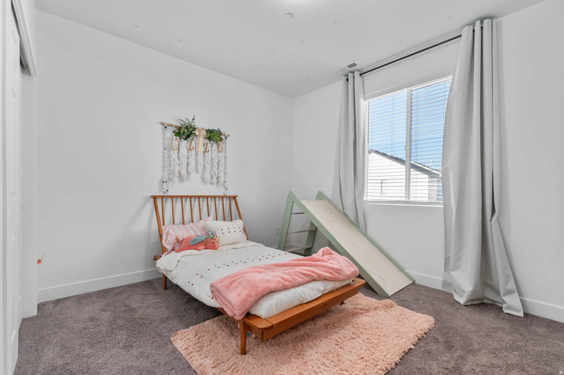 Bedroom with dark colored carpet