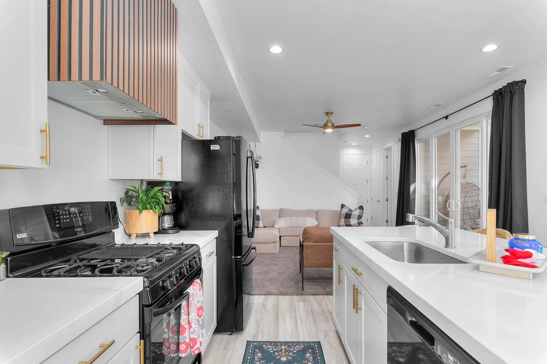 Kitchen featuring black appliances, gas stove large island