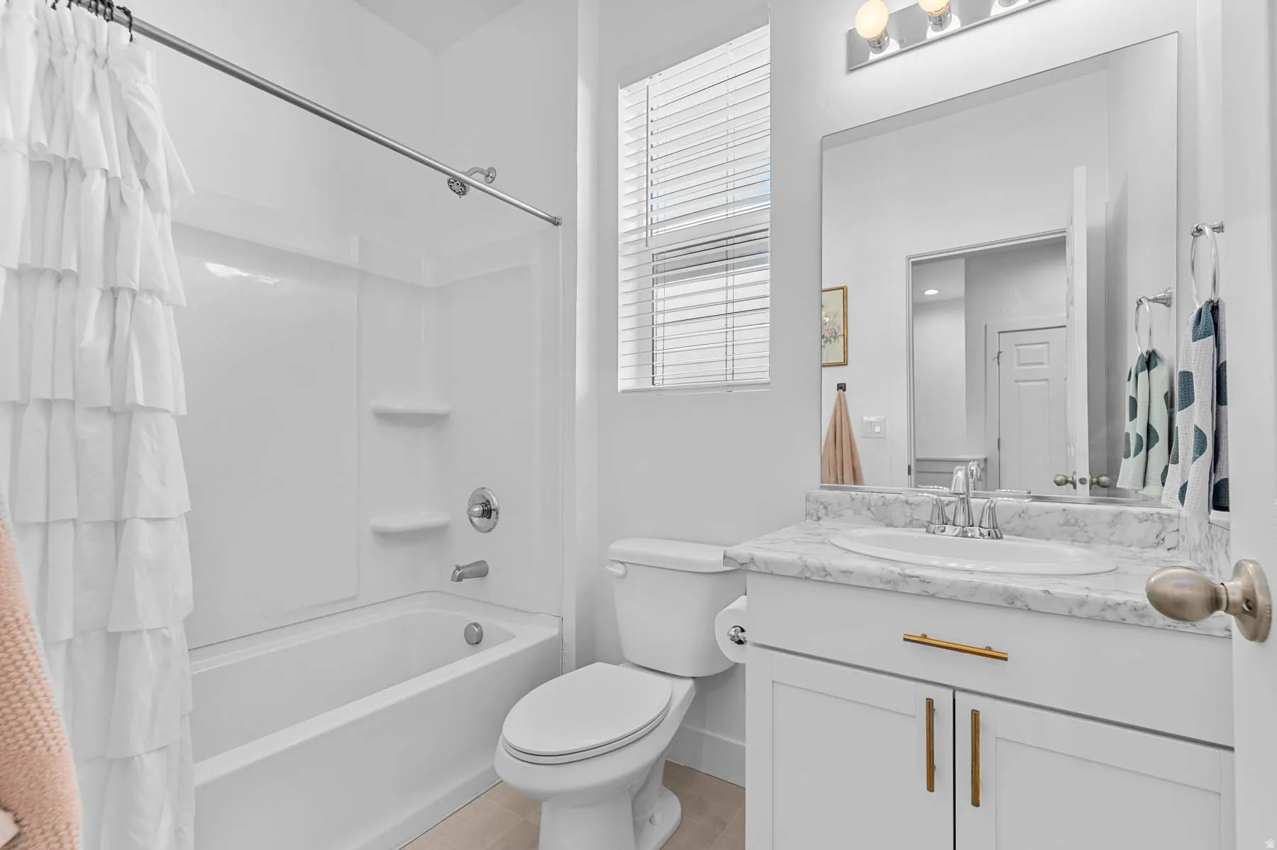 Main Bathroom with shower / bath combination with curtain and vanity