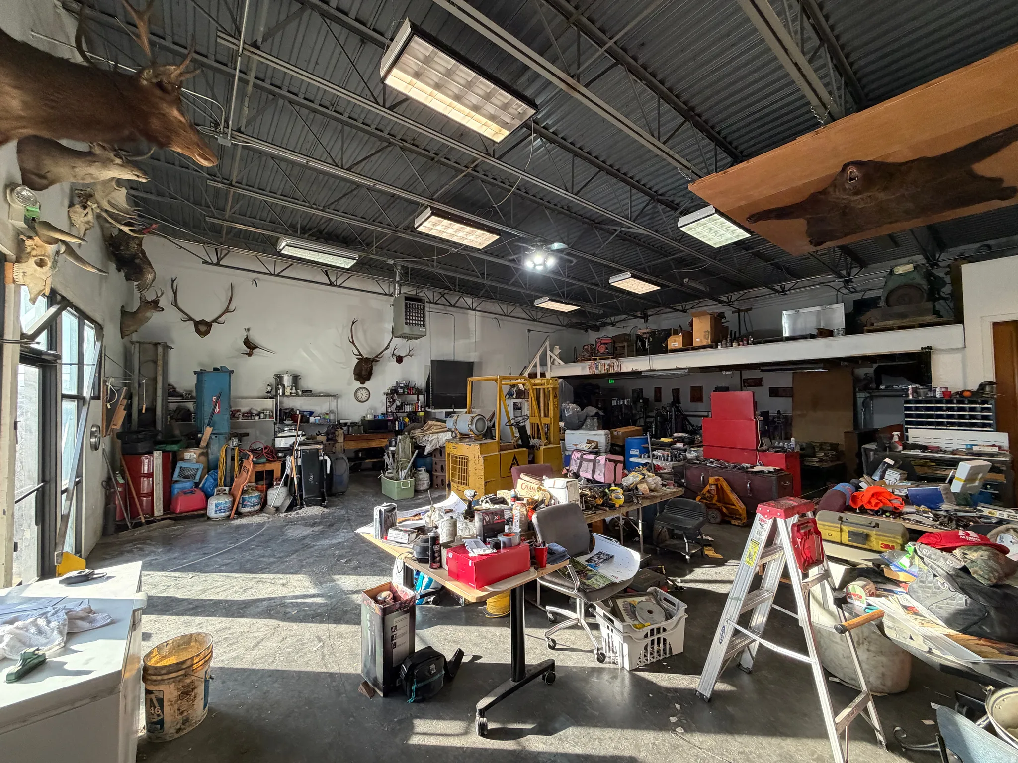 Misc room with a workshop area, a garage, and a heating unit