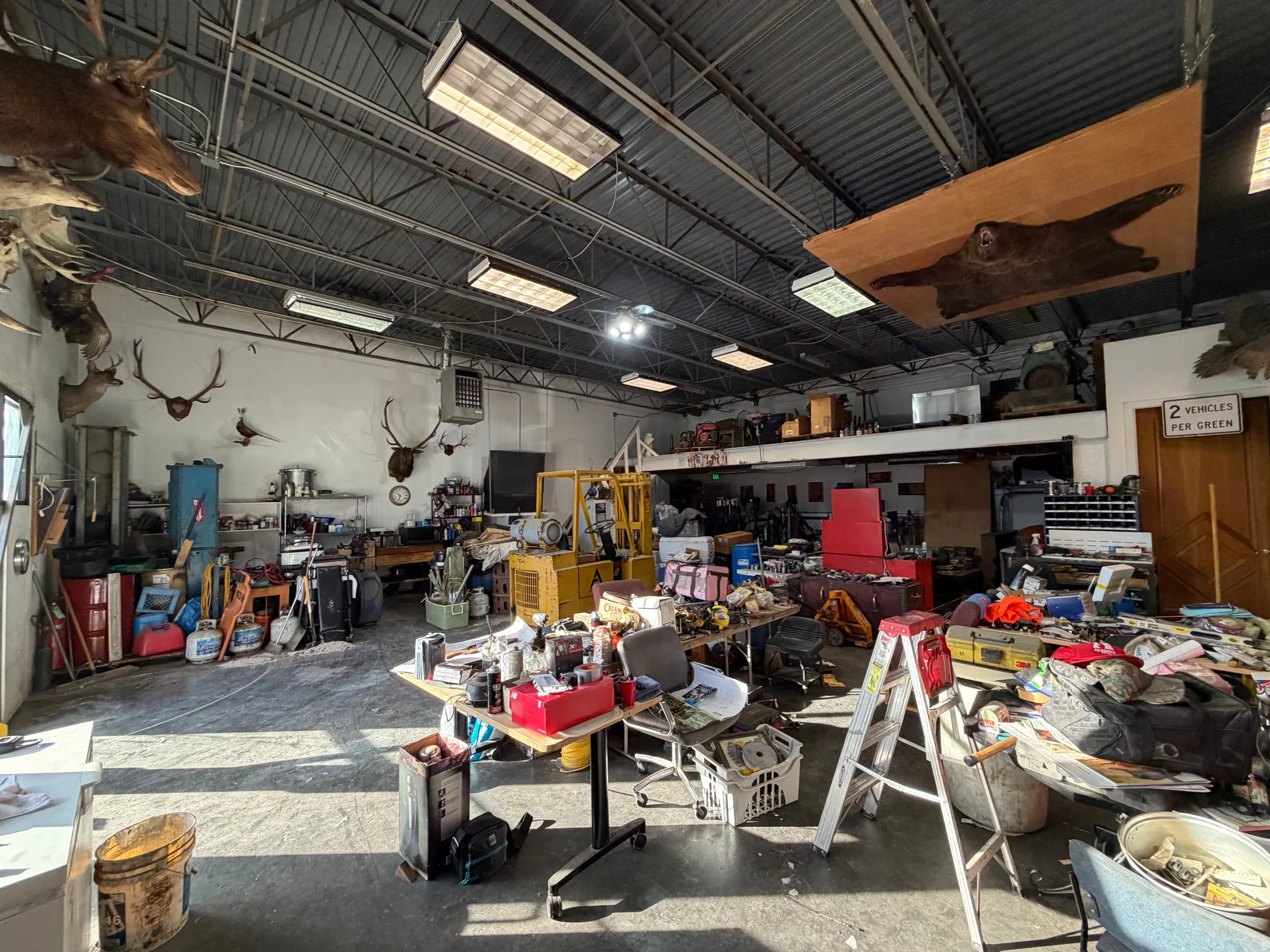 Misc room featuring a workshop area, a garage, and a heating unit