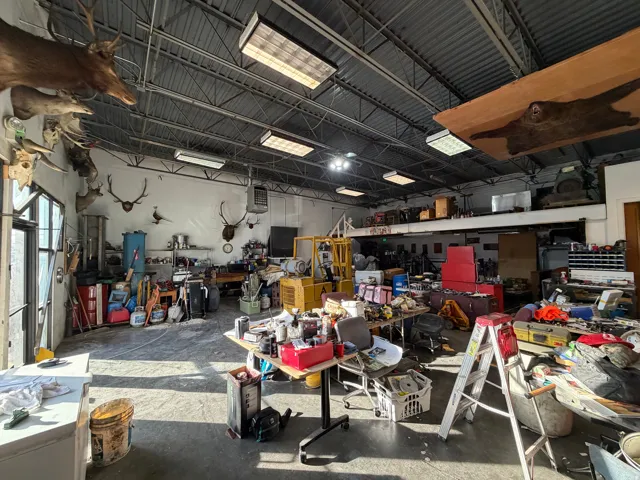 Misc room with a workshop area, a garage, and a heating unit
